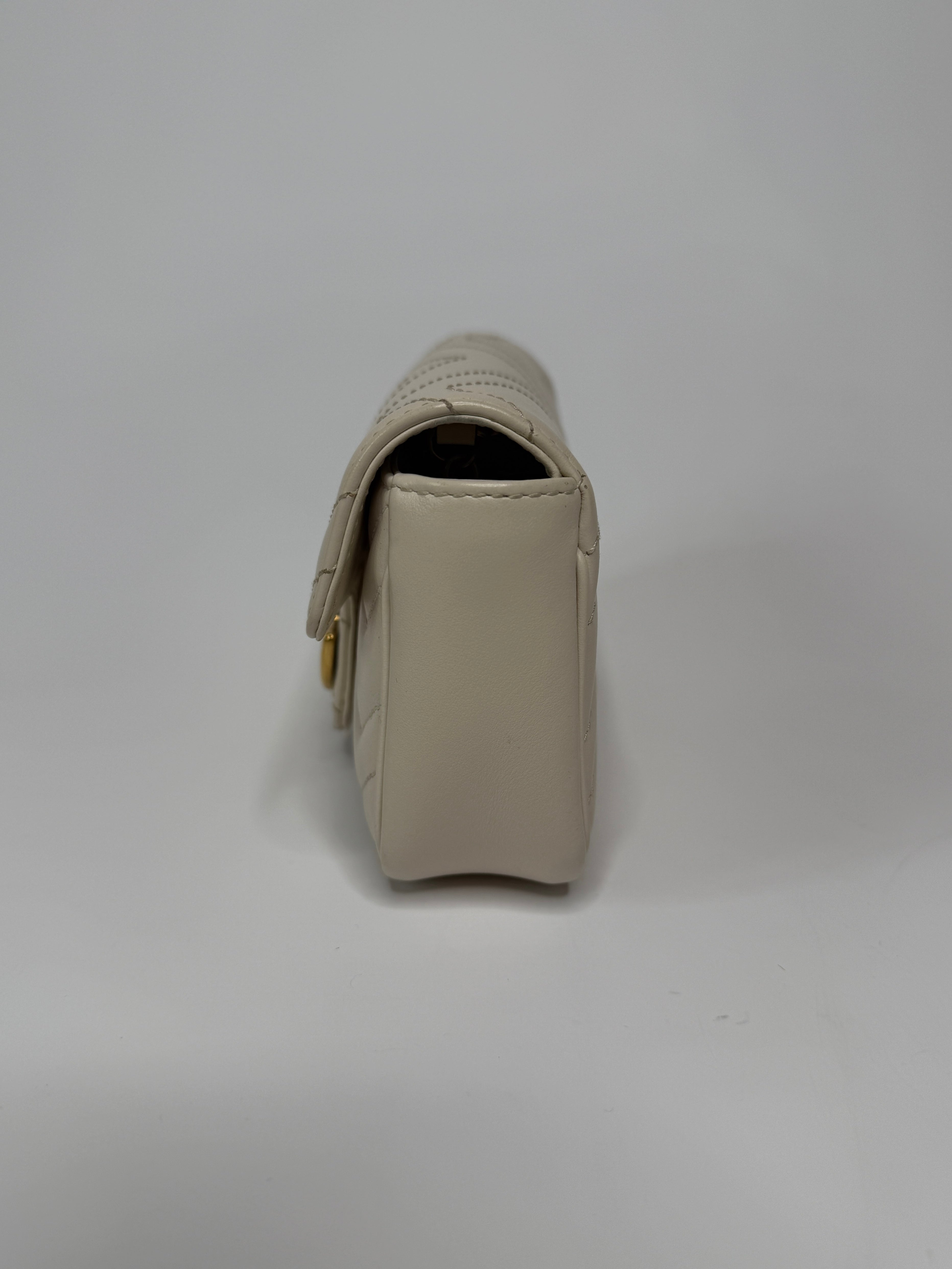 Gucci Marmont White Matelassé Super Mini Bag With Gold Hardware In Excellent pre loved condition. Authentic and preloved