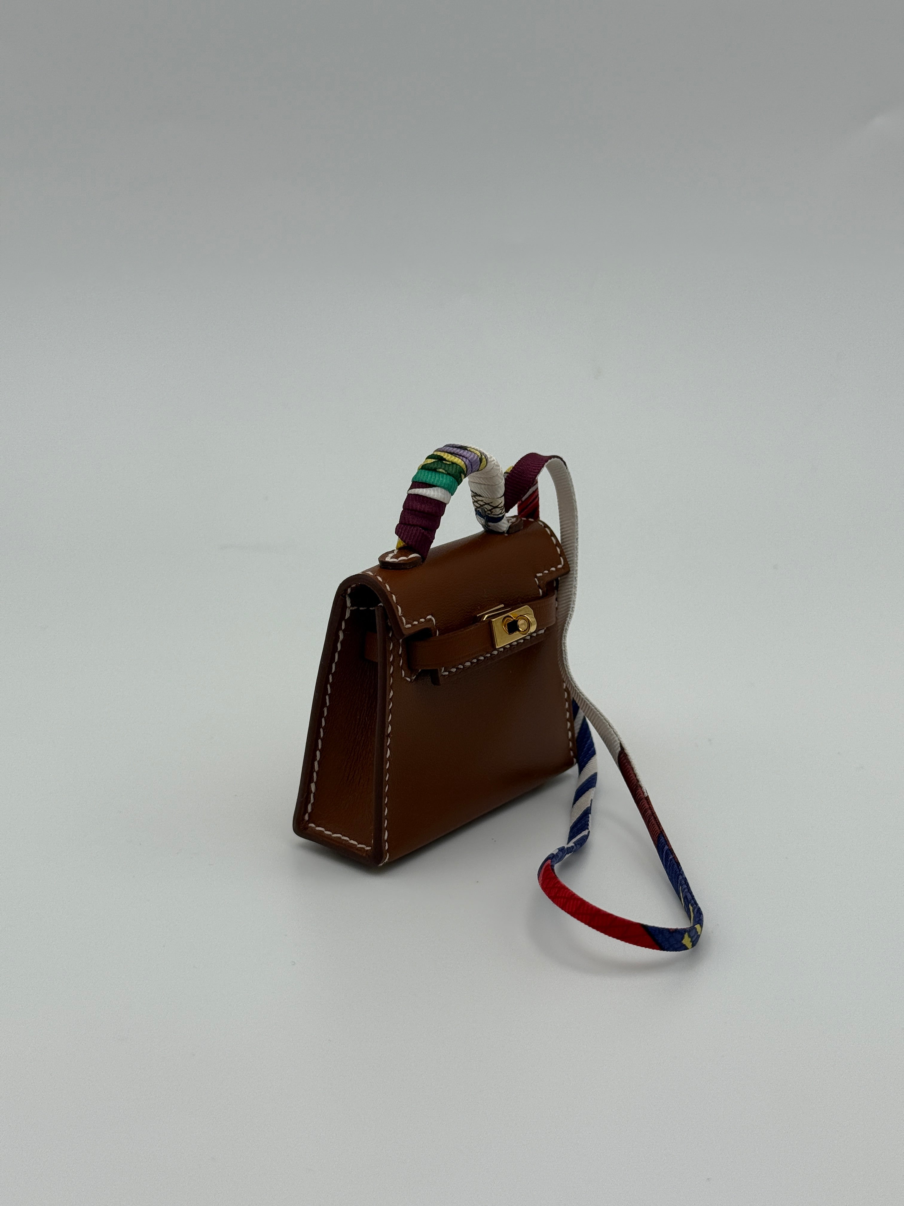 Hermès Kelly Twilly Charm In Gold Tadelakt Leather With GHW