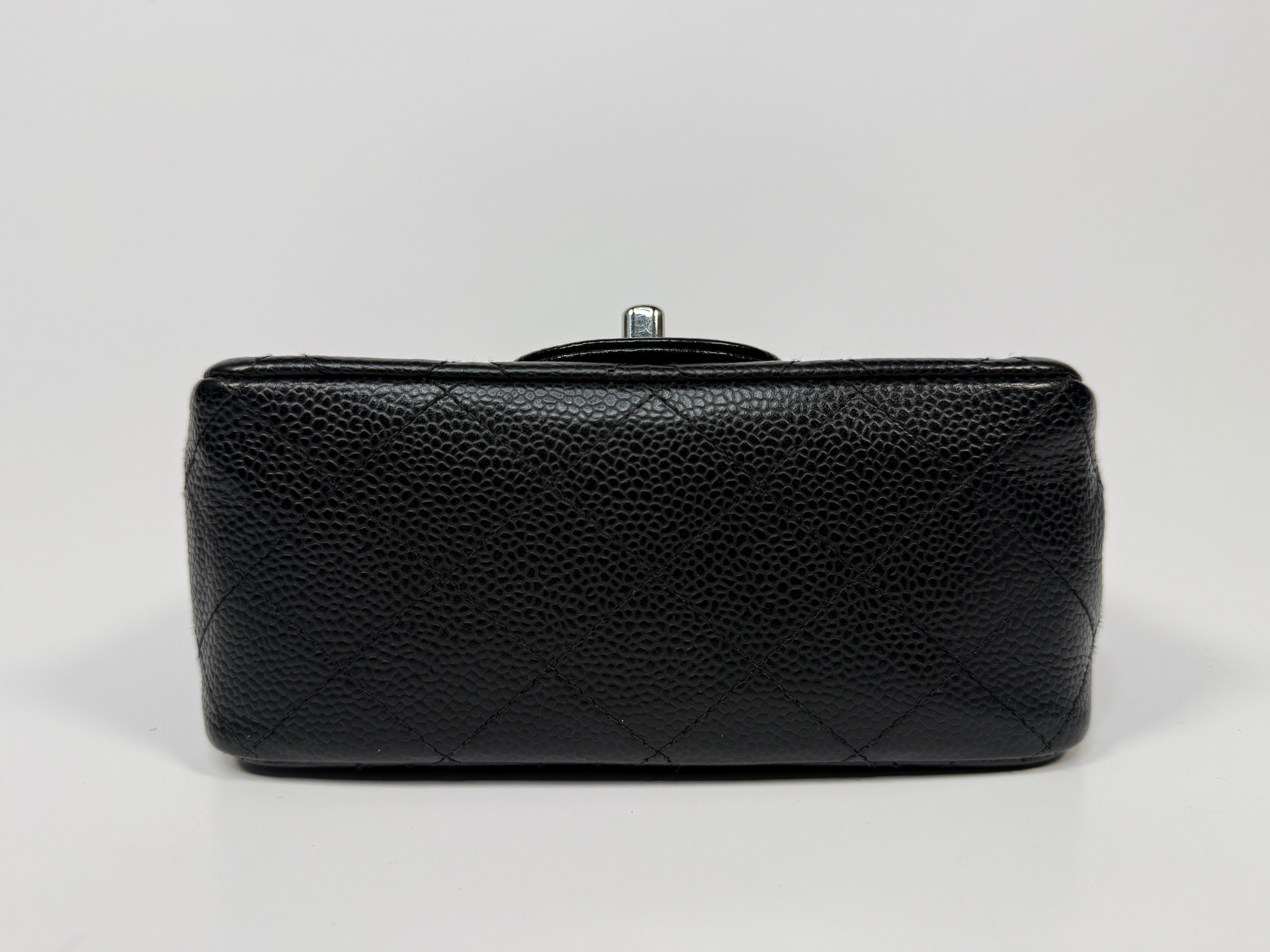 Chanel Black Square Flap Bag In Black Caviar Leather With Silver Hardware. Excellent condition. Authentic and preloved.