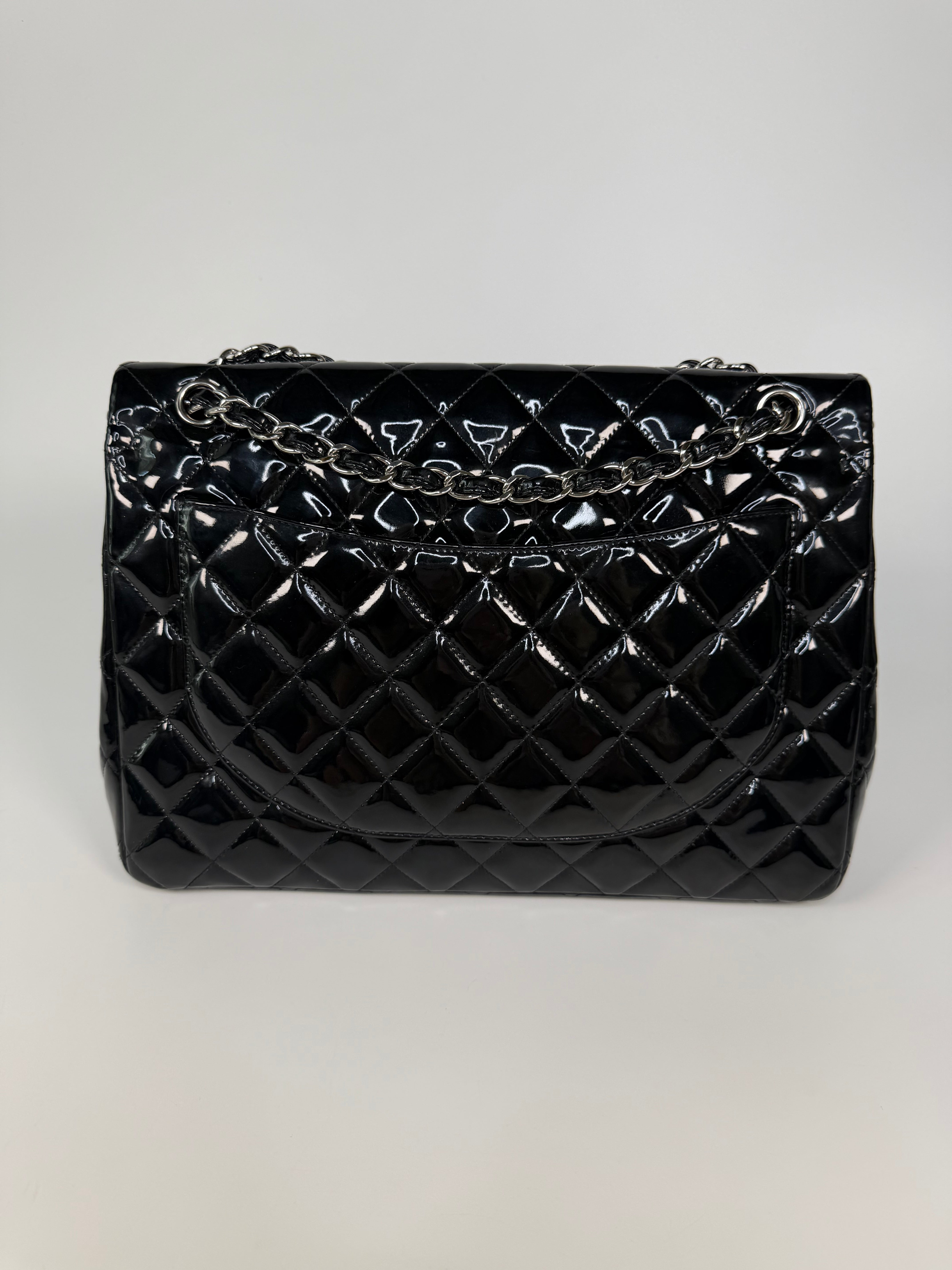 Chanel Maxi Classic Double Flap In Black Patent Leather With Silver Hardware. 100% authentic and preloved in excellent condition.