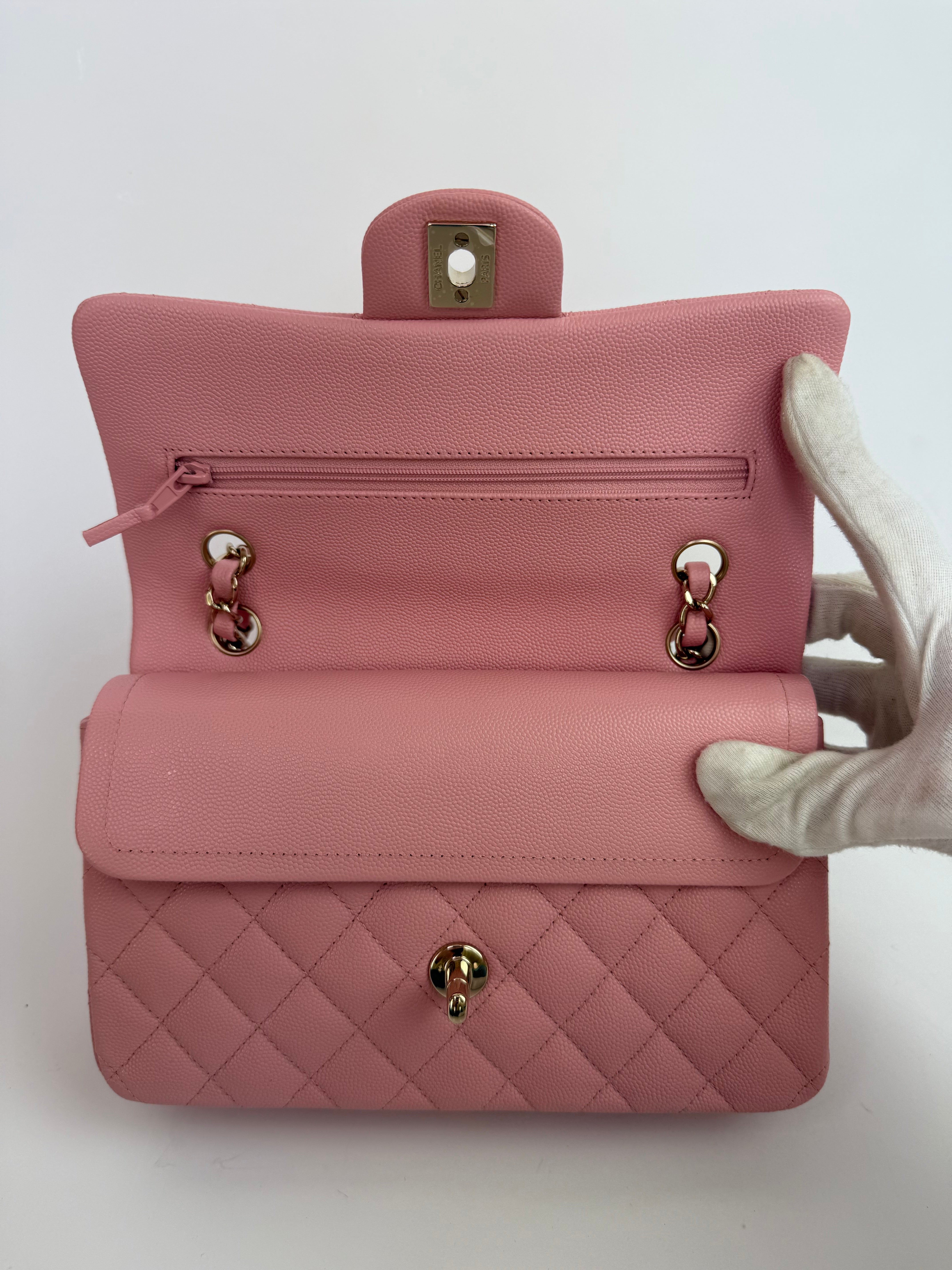 Authentic pre-loved Chanel Small Classic Double Flap In Pink Caviar Leather With Gold Hardware.