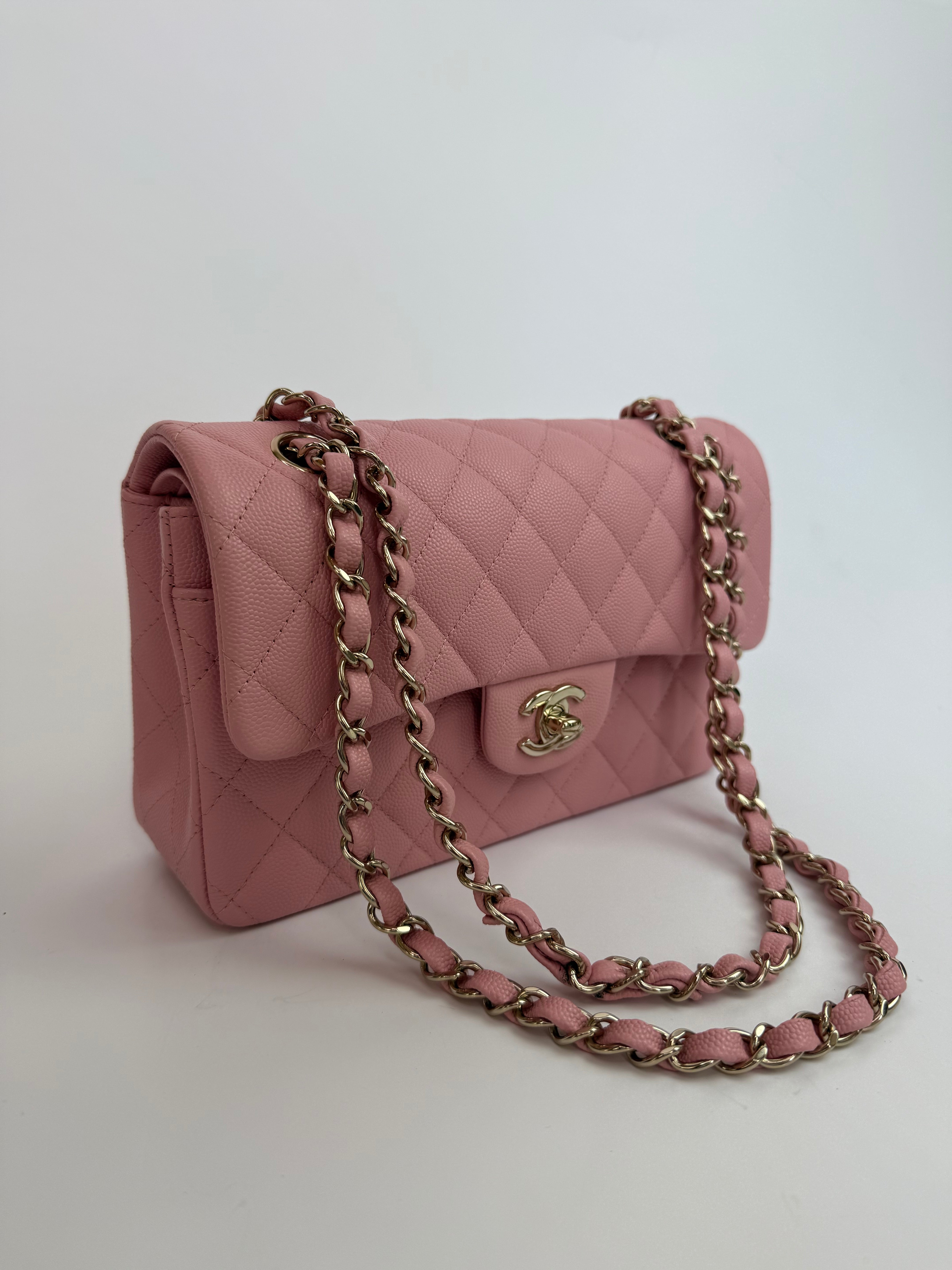 Authentic pre-loved Chanel Small Classic Double Flap In Pink Caviar Leather With Gold Hardware.