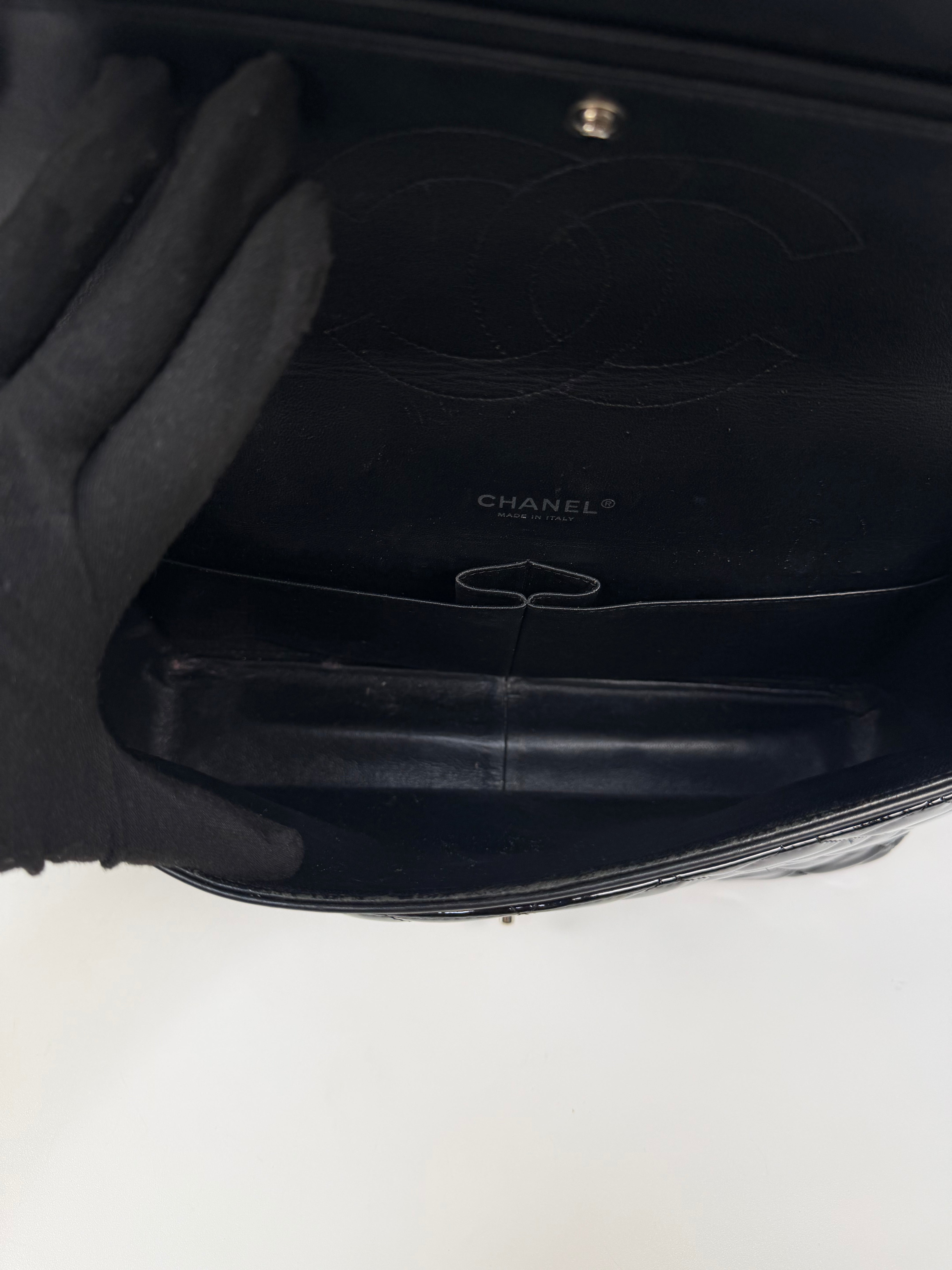 Chanel Maxi Classic Double Flap In Black Patent Leather With Silver Hardware. 100% authentic and preloved in excellent condition.