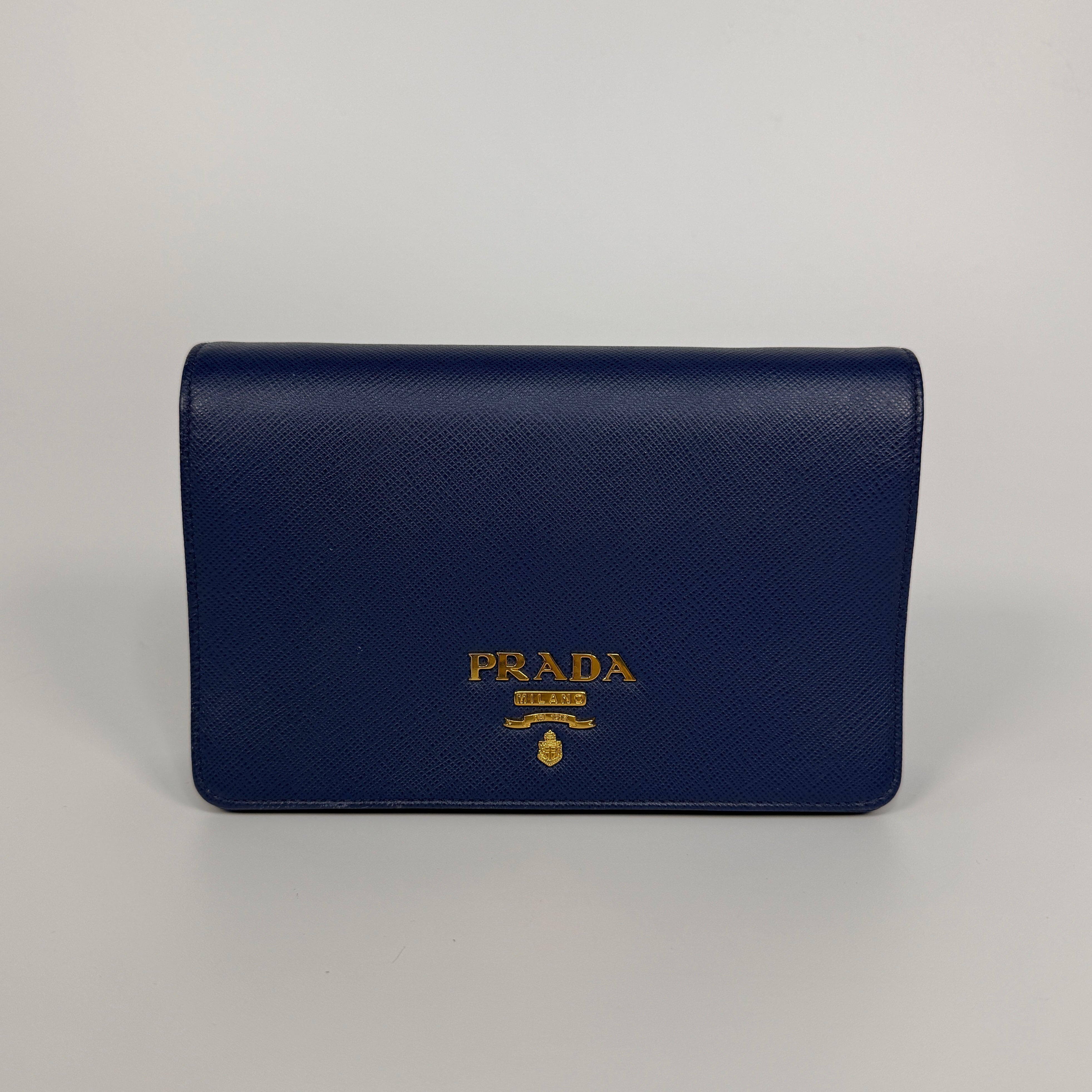 Authentic and preloved Prada Wallet Chain Bag In Blue Saffiano Leather With Gold Hardware. Very Good condition. 100% Authenticity guarantee