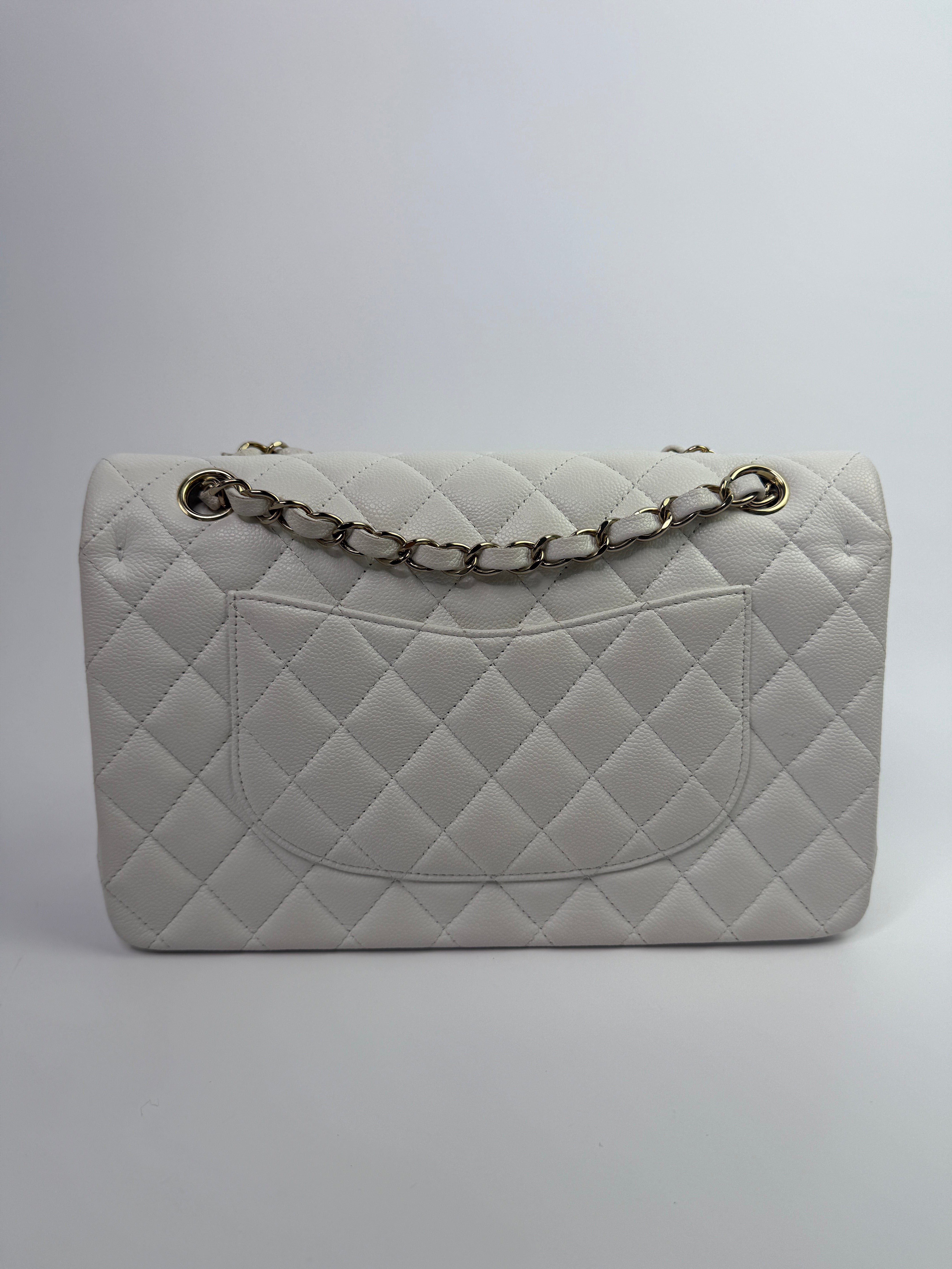 Authentic pre-loved Chanel Medium Classic Double Flap White Caviar Leather With Gold Hardware.