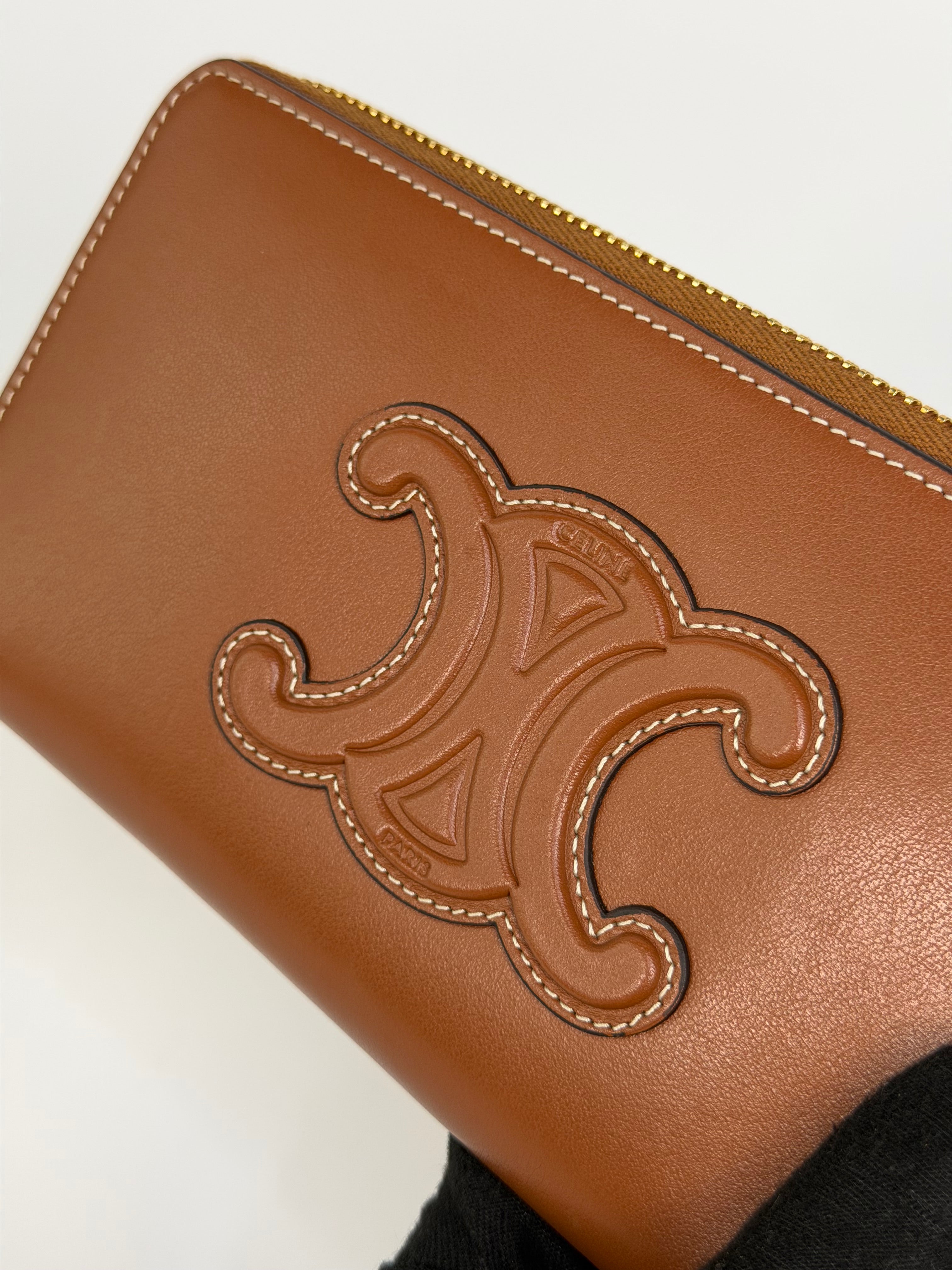 Celine Triomphe Long Wallet In Tan Calfskin With Gold Hardware. Authentic and preloved in excellent condition