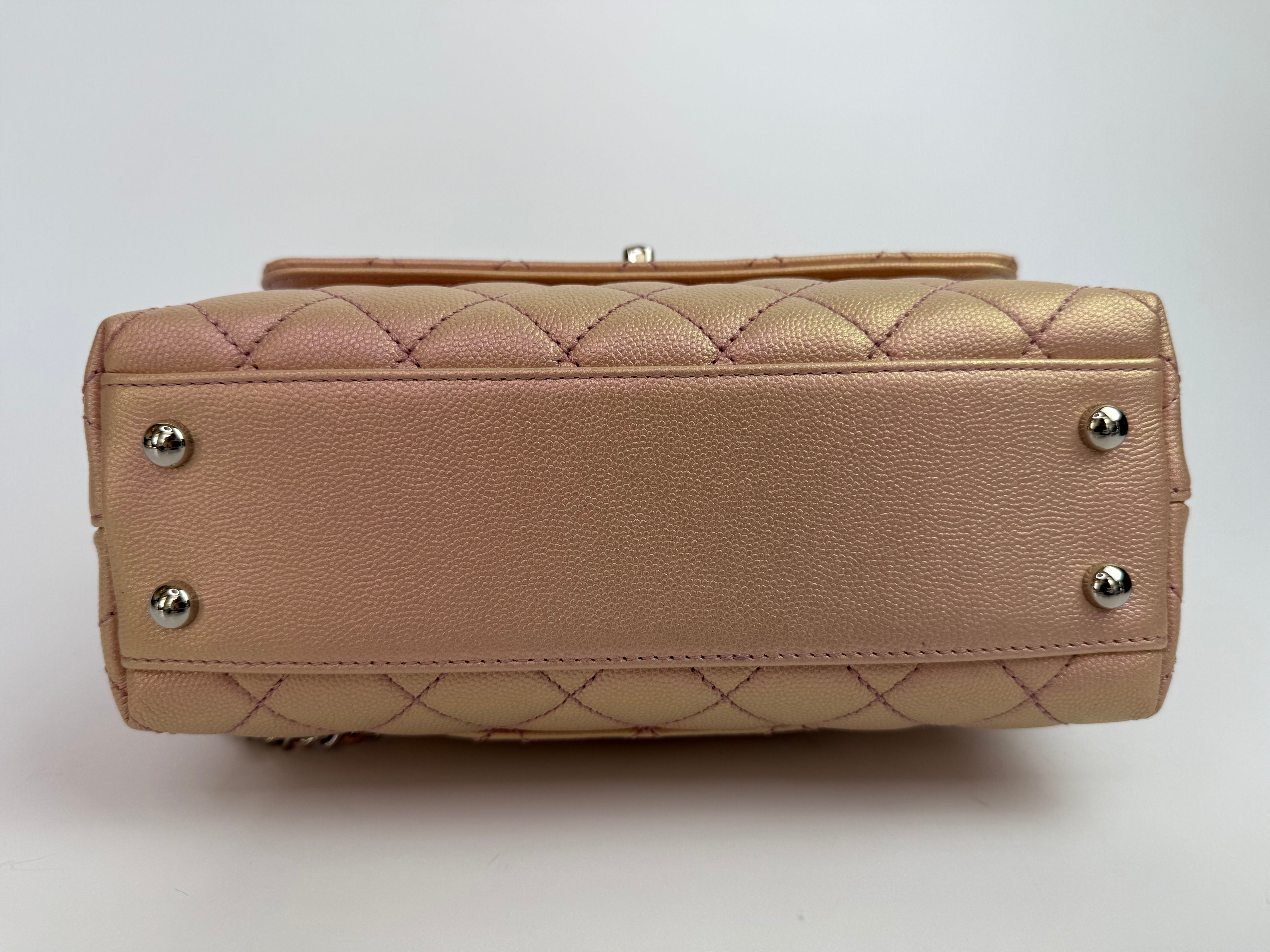 Authentic pre-loved Chanel Small Coco In Iridescent Pink Caviar With Rainbow Hardware.