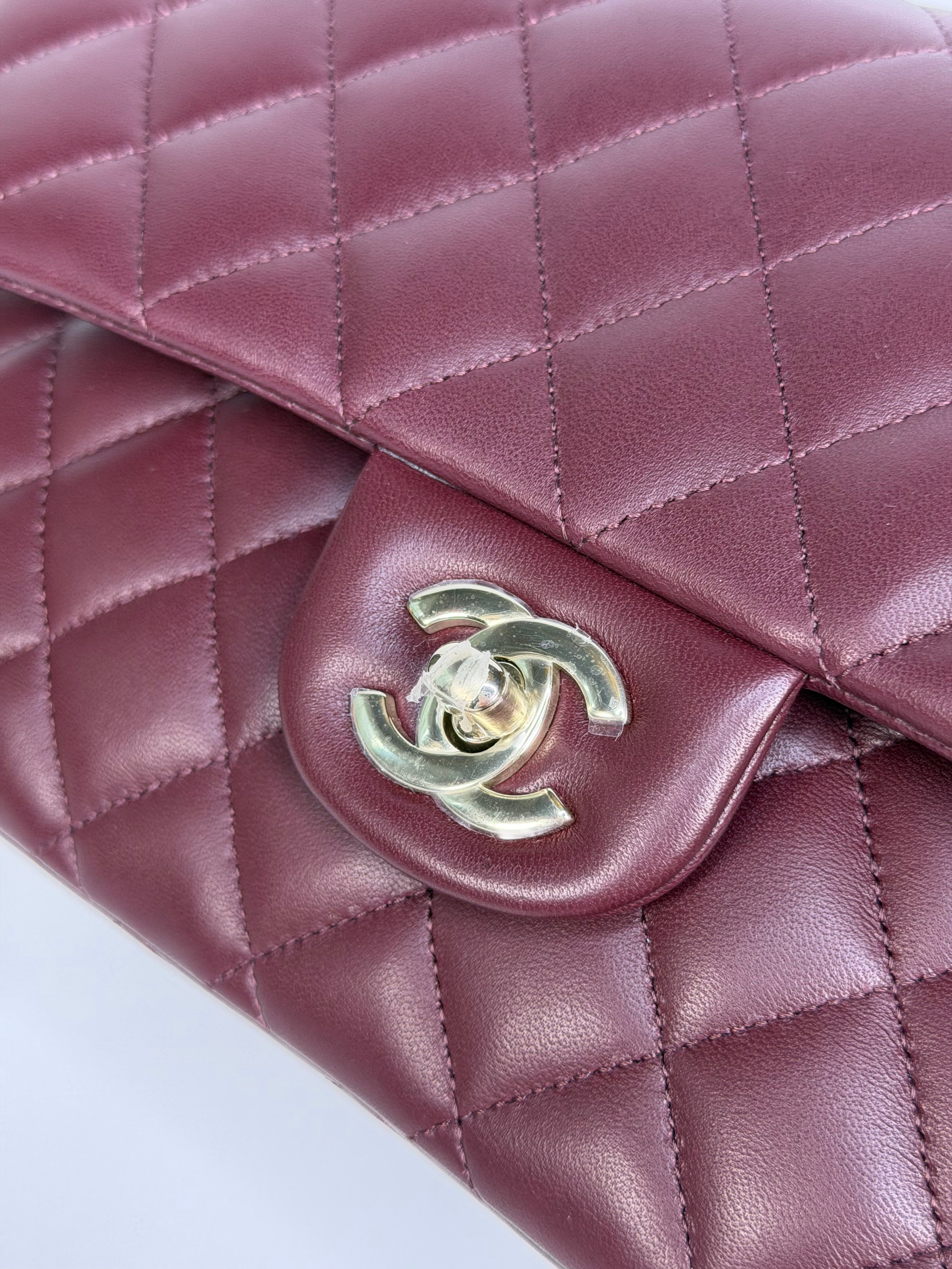 Chanel Medium Classic Double Flap Burgundy Lambskin Leather With Pale Gold Hardware. Authentic and preloved in excellent condition with 100% authenticity guarantee.