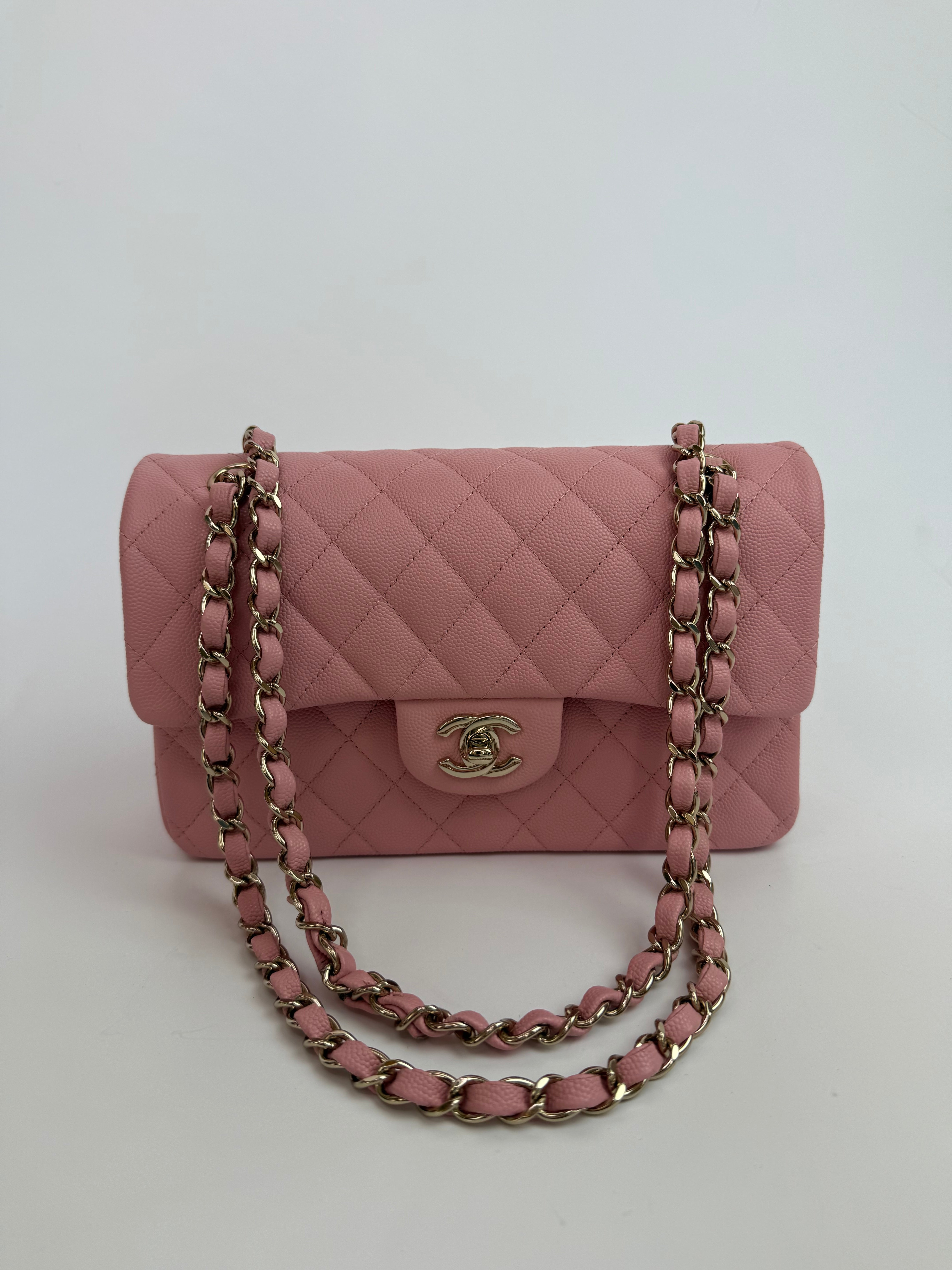 Authentic pre-loved Chanel Small Classic Double Flap In Pink Caviar Leather With Gold Hardware.