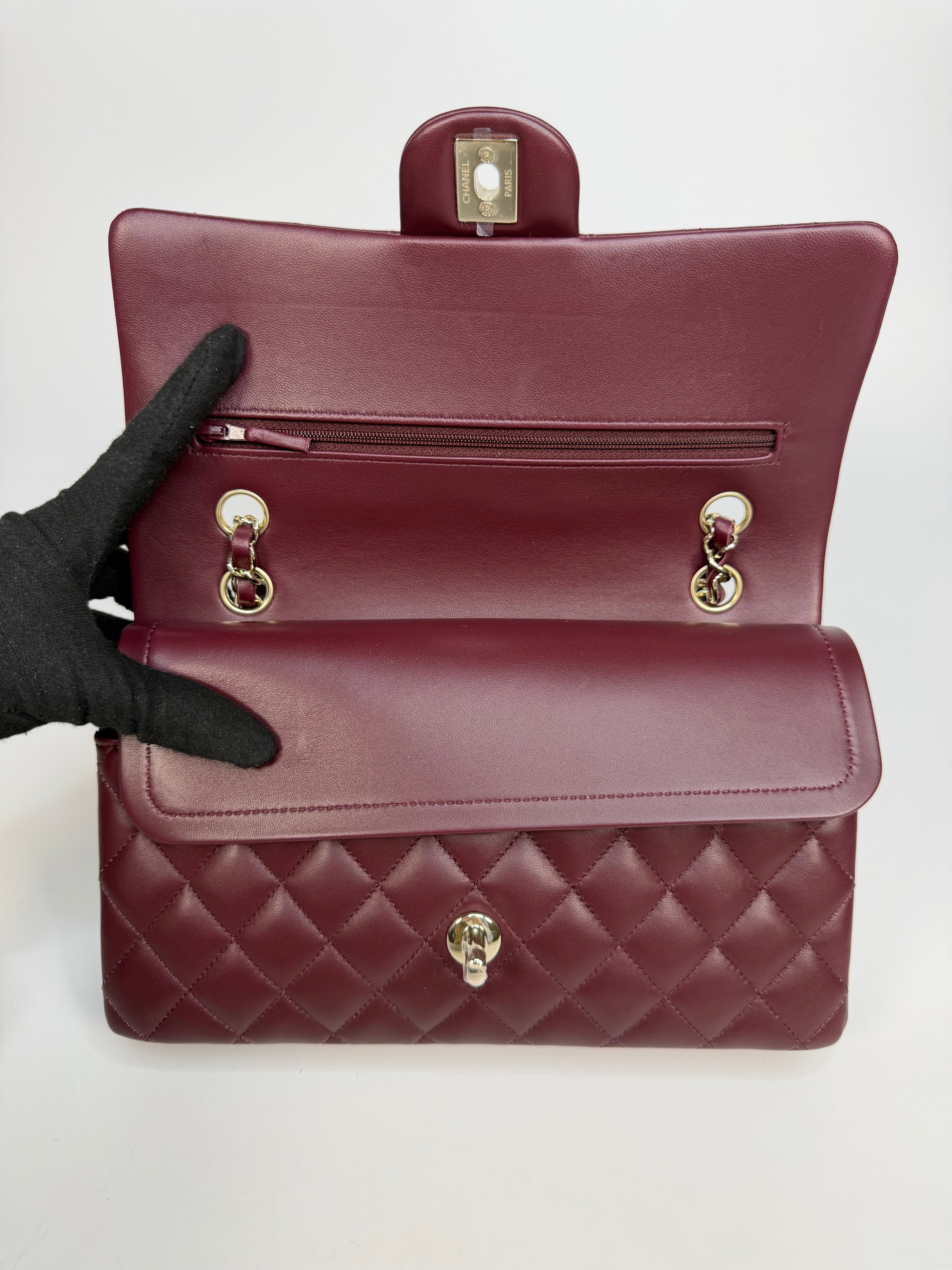 Chanel Medium Classic Double Flap Burgundy Lambskin Leather With Pale Gold Hardware. Authentic and preloved in excellent condition with 100% authenticity guarantee.