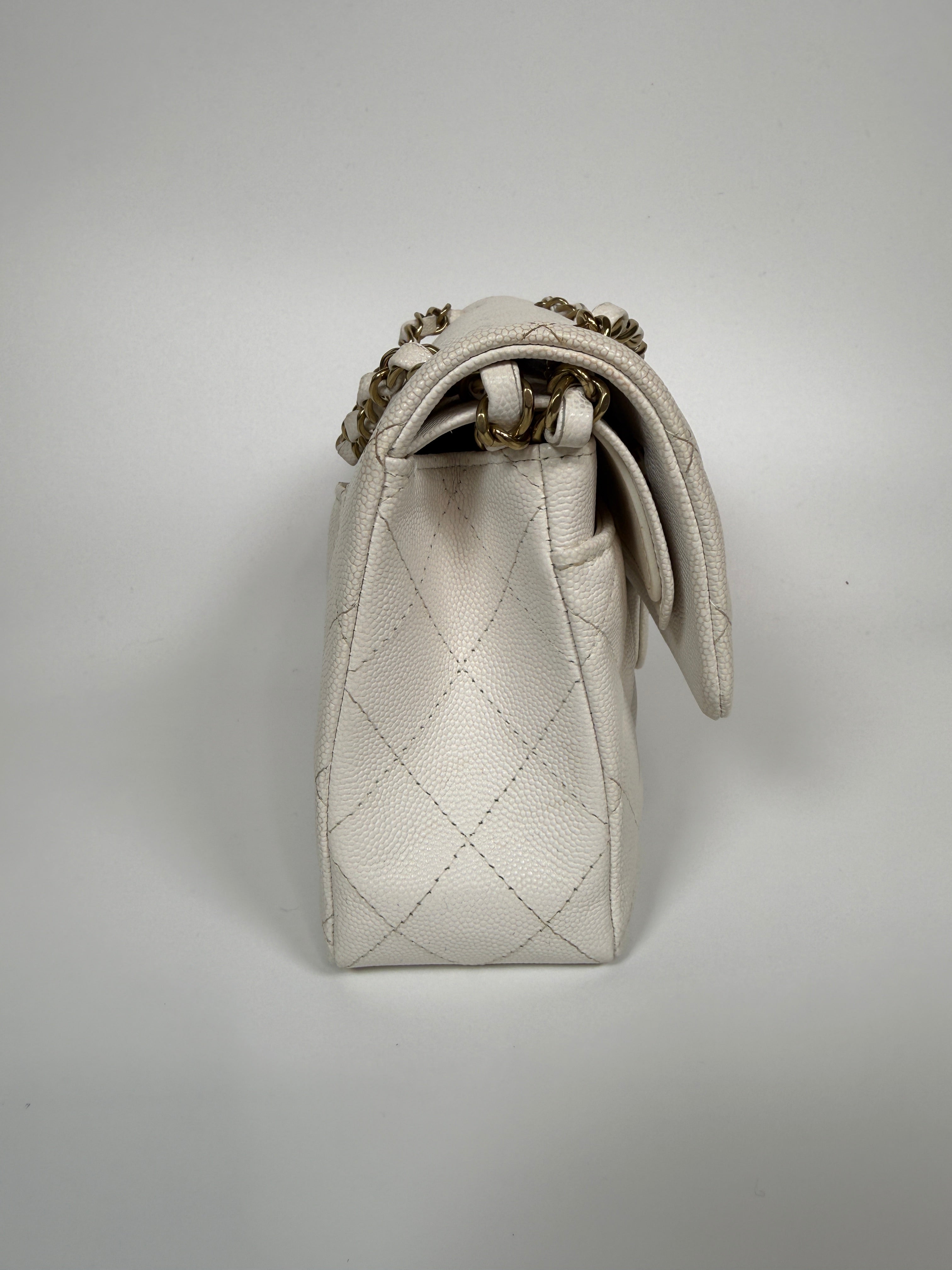 Authentic and preloved Chanel Small Classic Double Flap In White Caviar Leather With pale gold hardware. Very Good Condition. 100% Authenticity guarantee