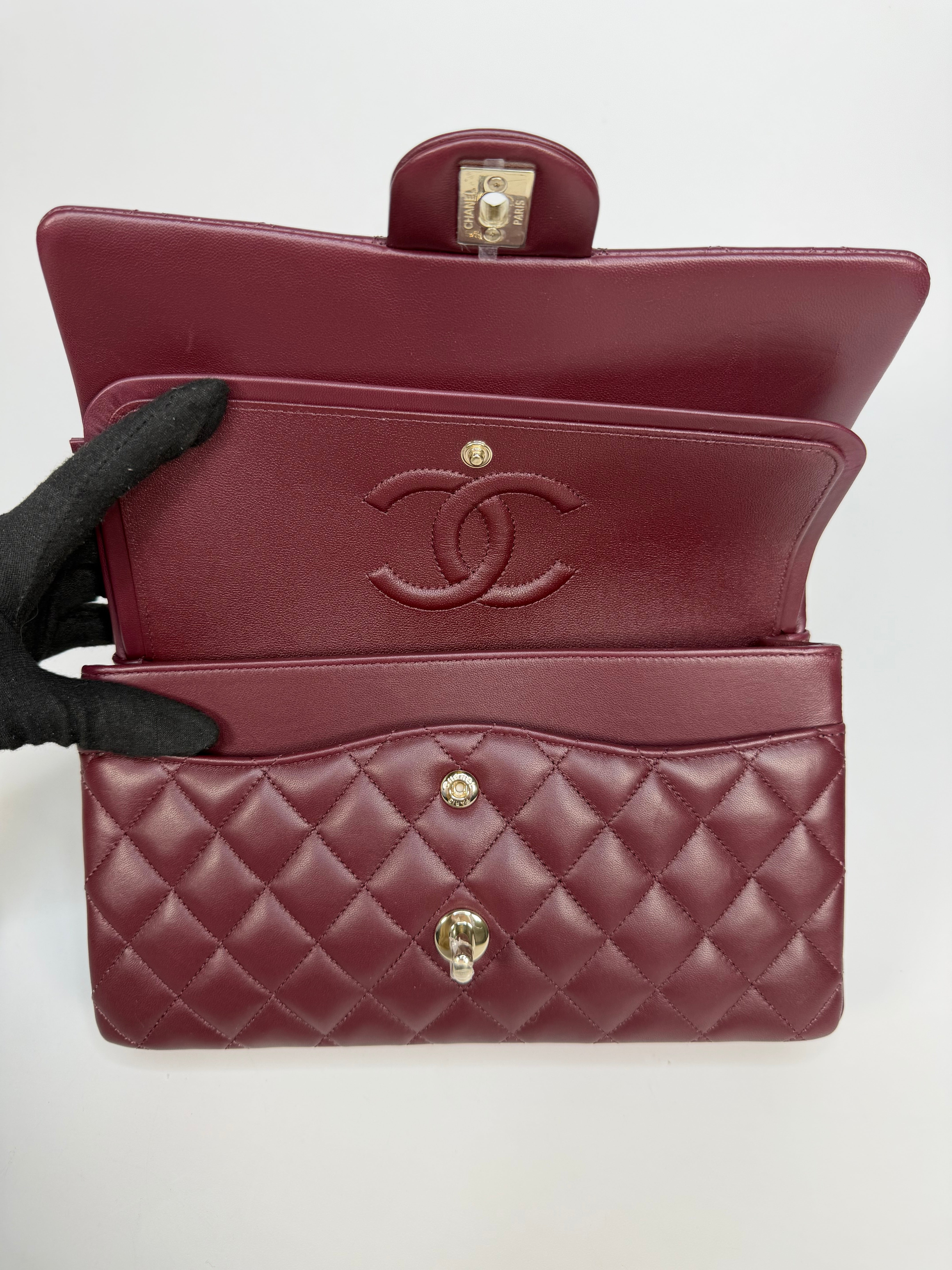 Chanel Medium Classic Double Flap Burgundy Lambskin Leather With Pale Gold Hardware. Authentic and preloved in excellent condition with 100% authenticity guarantee.
