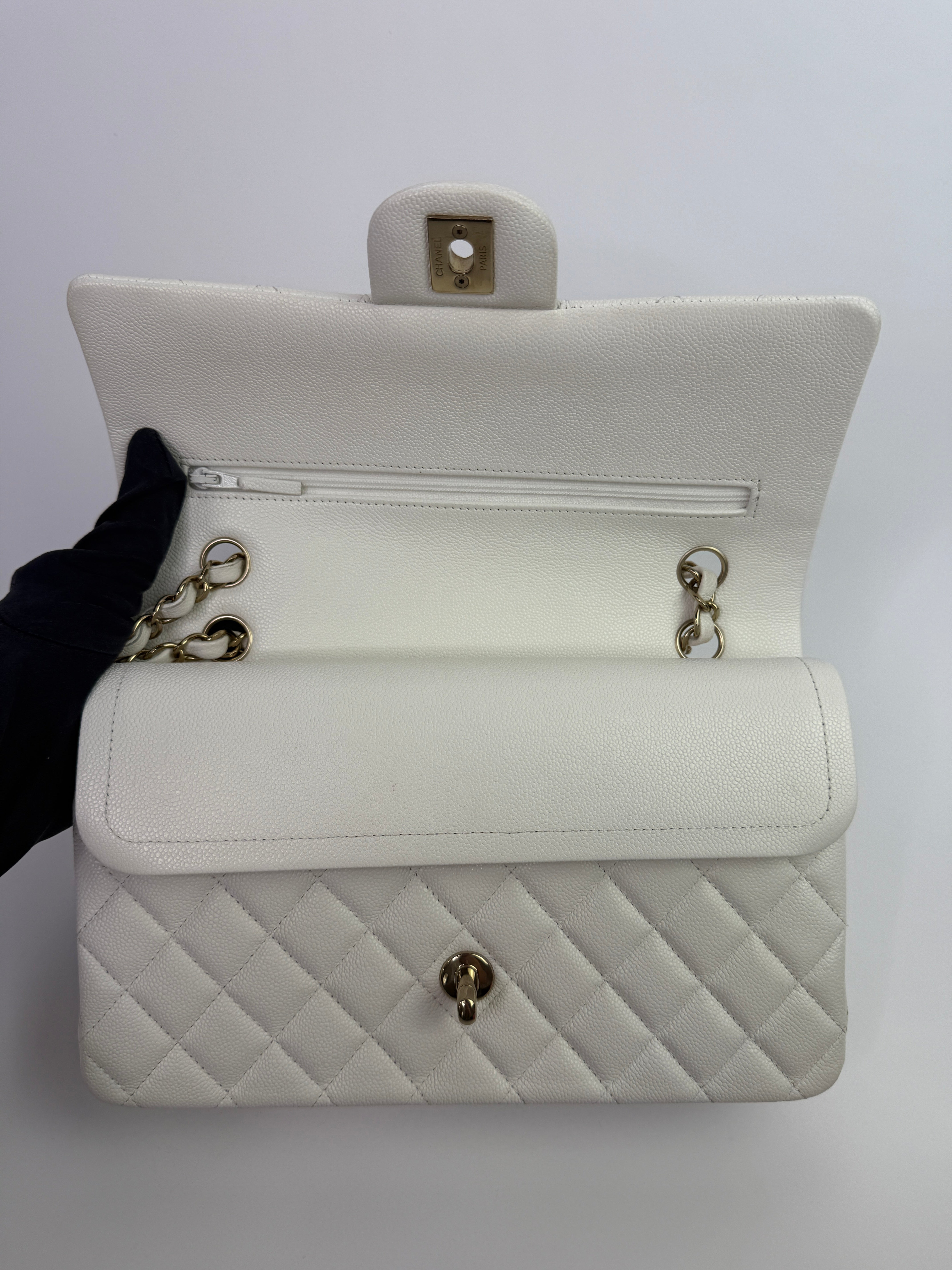 Authentic pre-loved Chanel Medium Classic Double Flap White Caviar Leather With Gold Hardware.