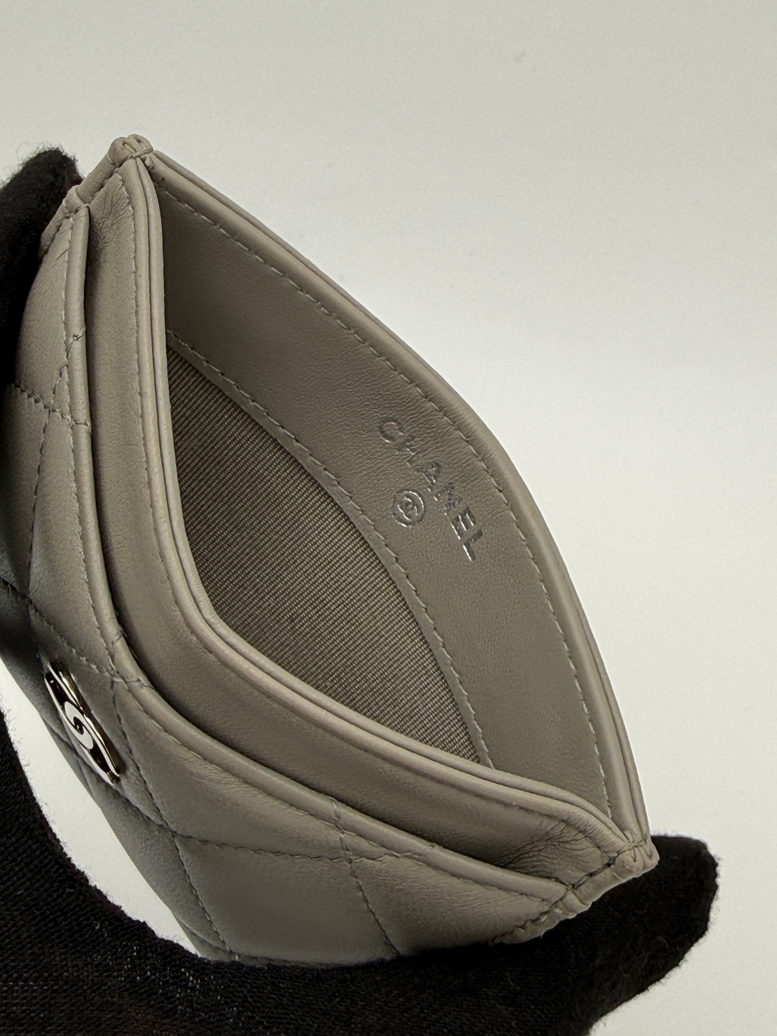 Authentic and pre loved Chanel Classic Card Holder In Grey Lambskin Leather With Silver hardware. Excellent Condition. 100% Authenticity guarantee.