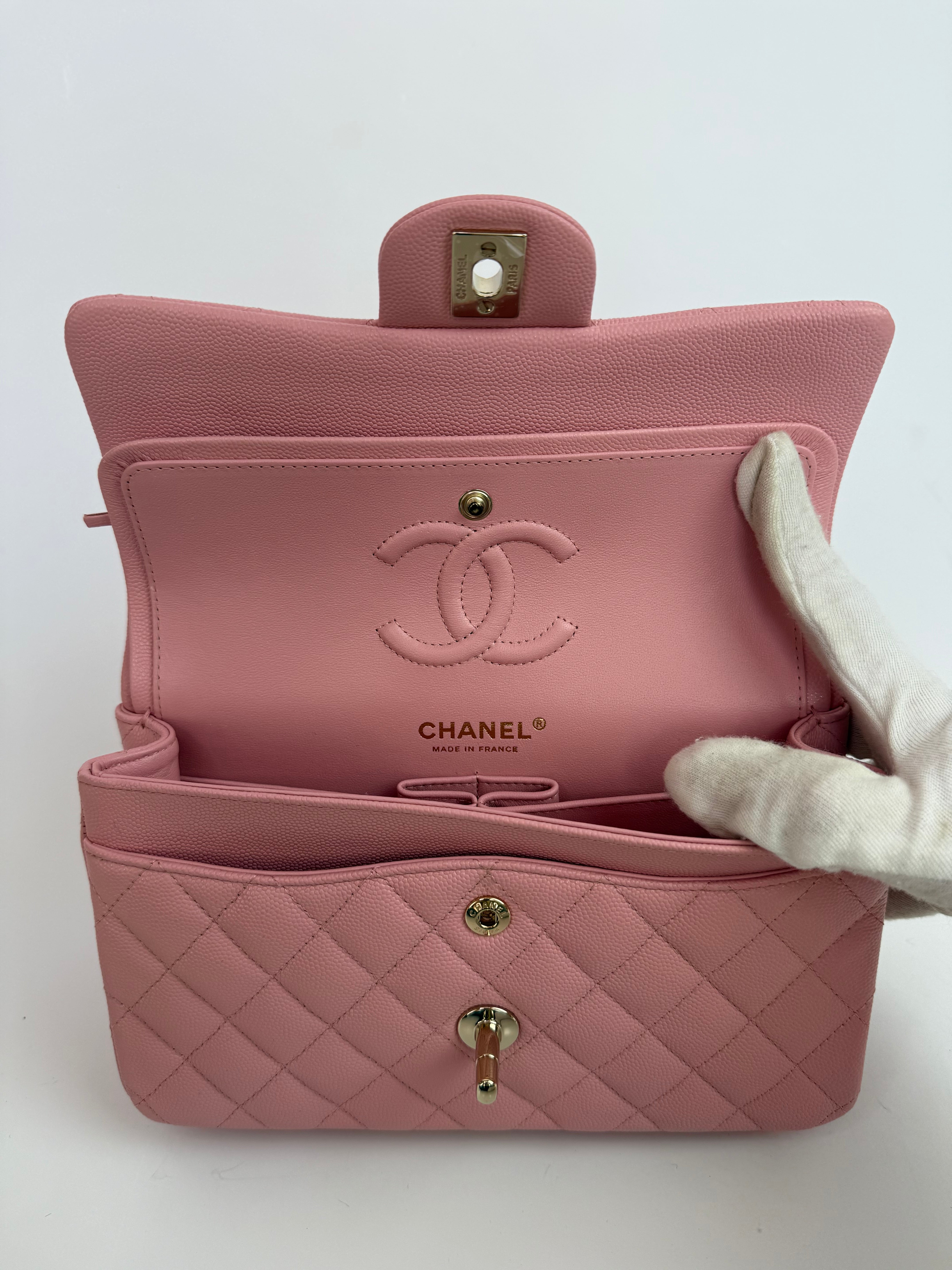 Authentic pre-loved Chanel Small Classic Double Flap In Pink Caviar Leather With Gold Hardware.