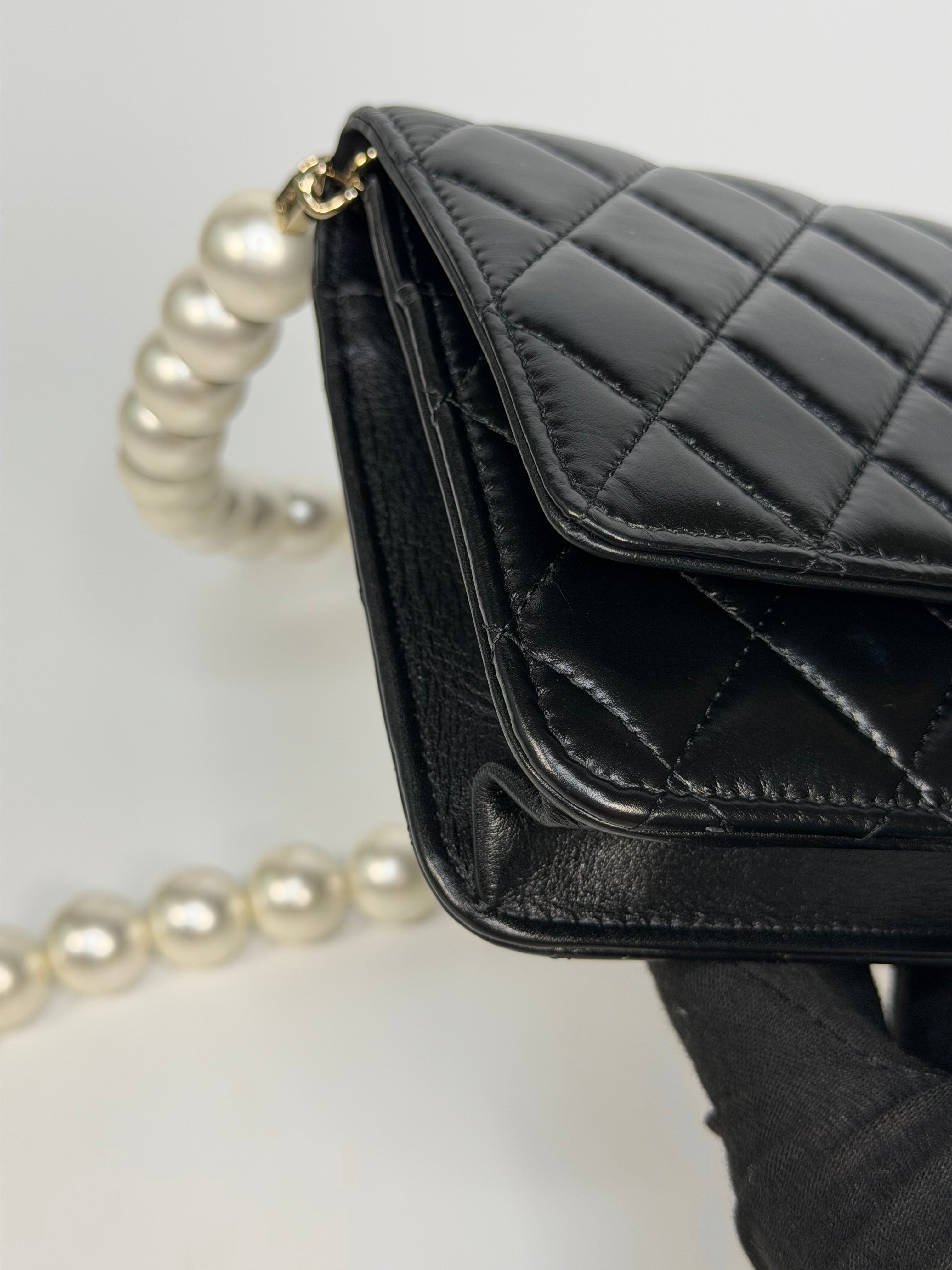 Chanel Pearl Wallet On Chain In Black Lambskin Leather With Gold Hardware. Authentic and preloved in very good condition.