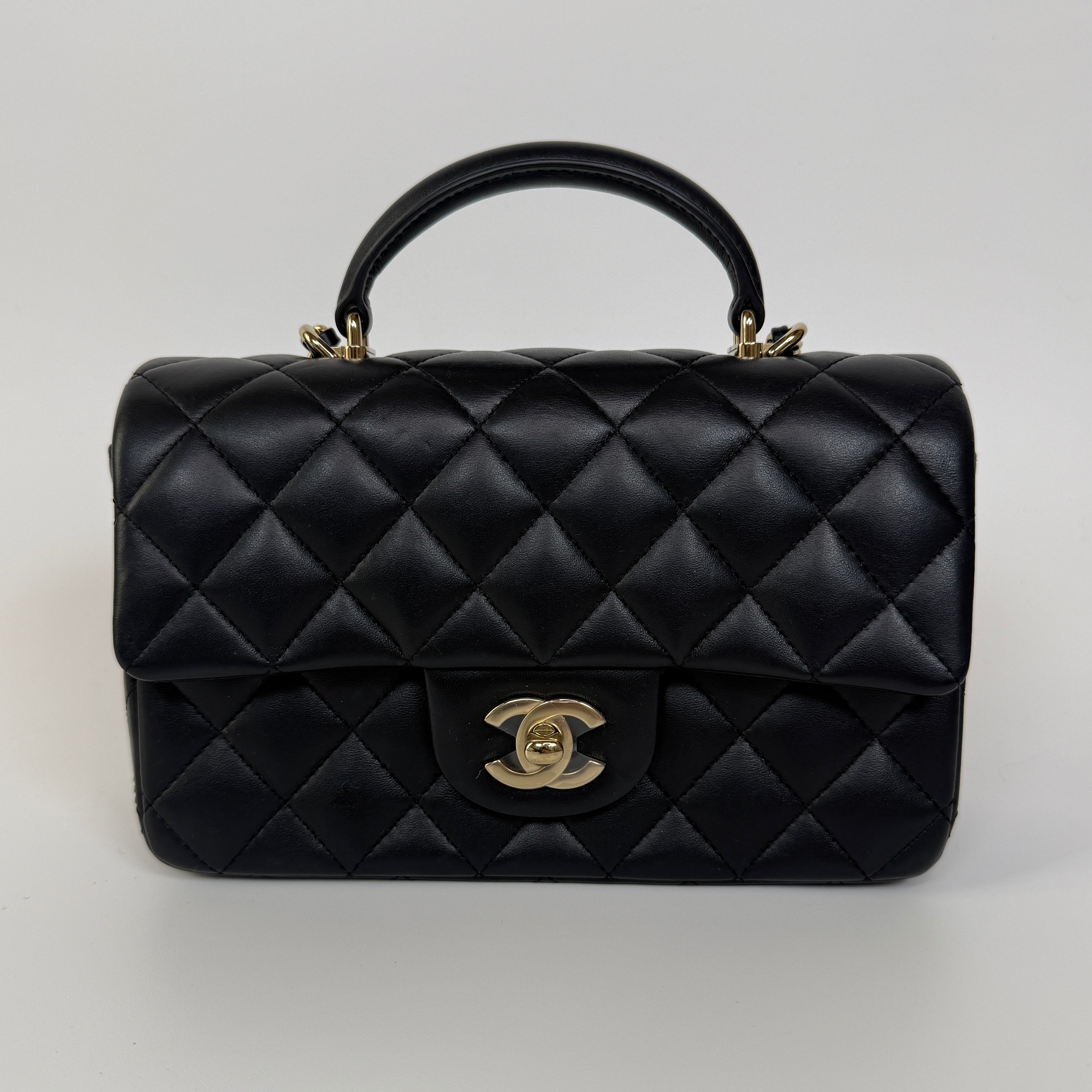 Authentic and preloved Chanel Mini Rectangle Top Handle Flap Bag In Black Lambskin With Gold hardware. Excellent Condition. 100% Authenticity guarantee