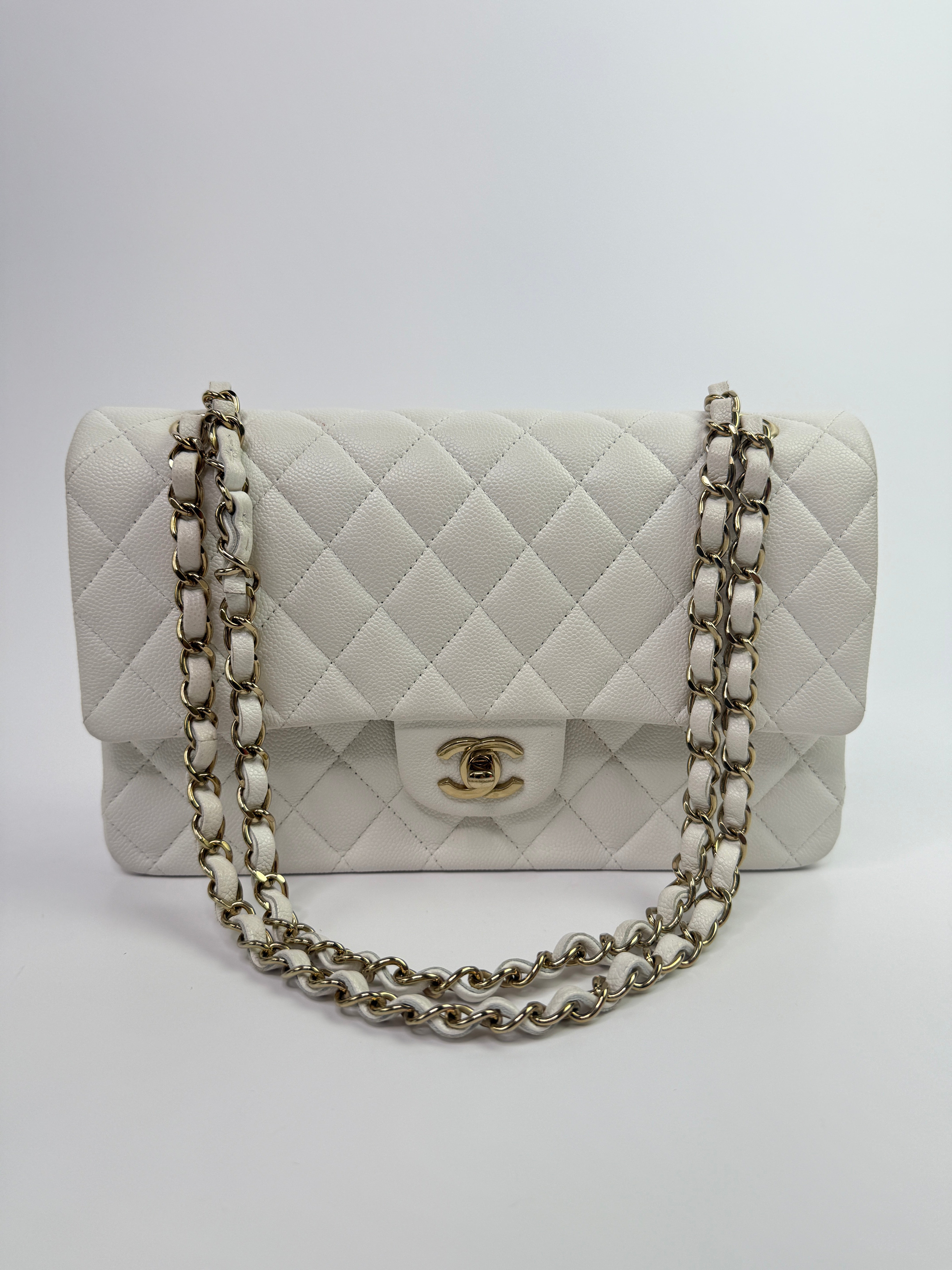 Authentic pre-loved Chanel Medium Classic Double Flap White Caviar Leather With Gold Hardware.