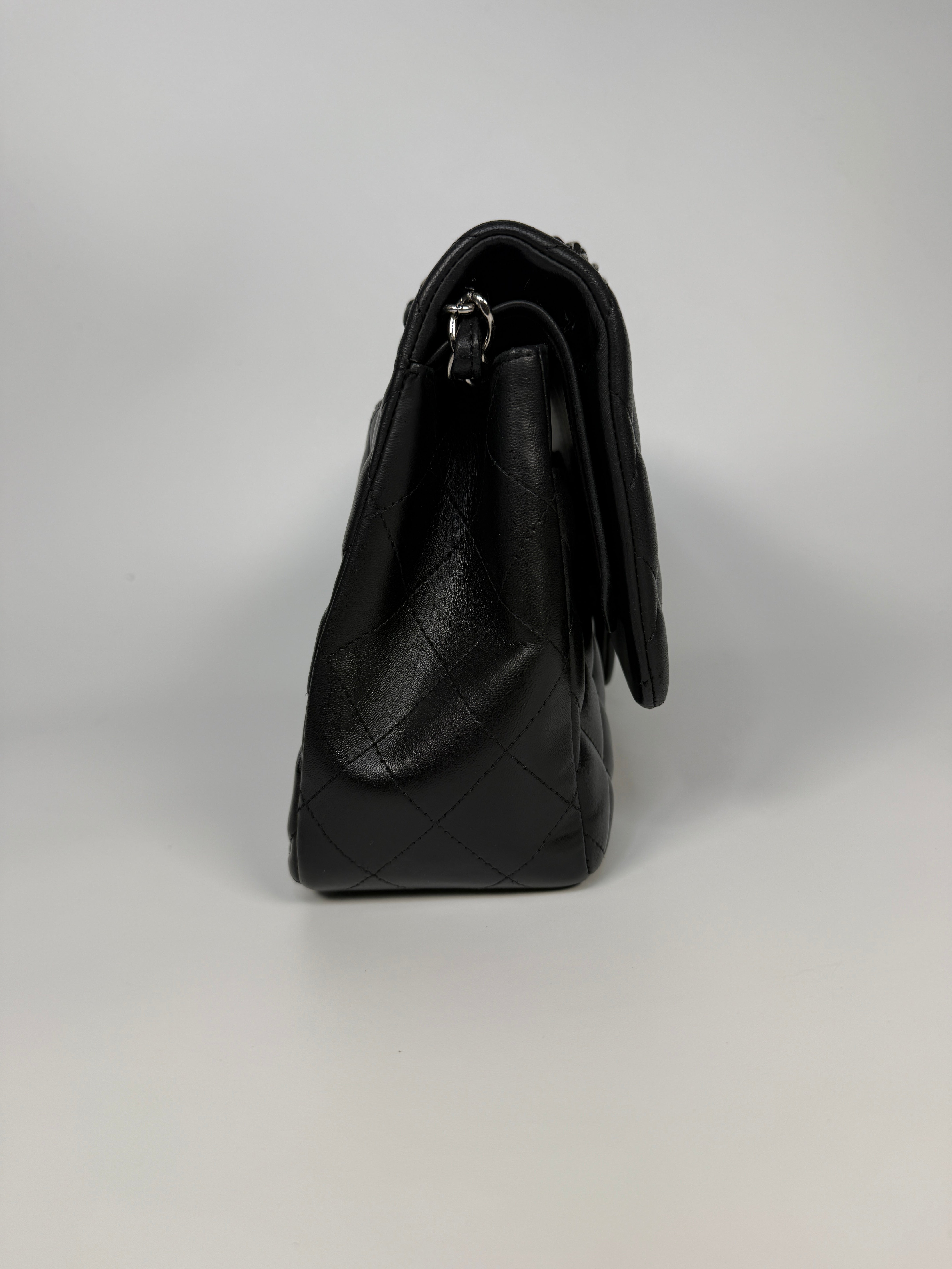 Authentic and preloved Chanel Jumbo Classic Flap Bag In Black Lambskin Leather With Silver hardware. Very Good condition. 100% Authenticity guarantee