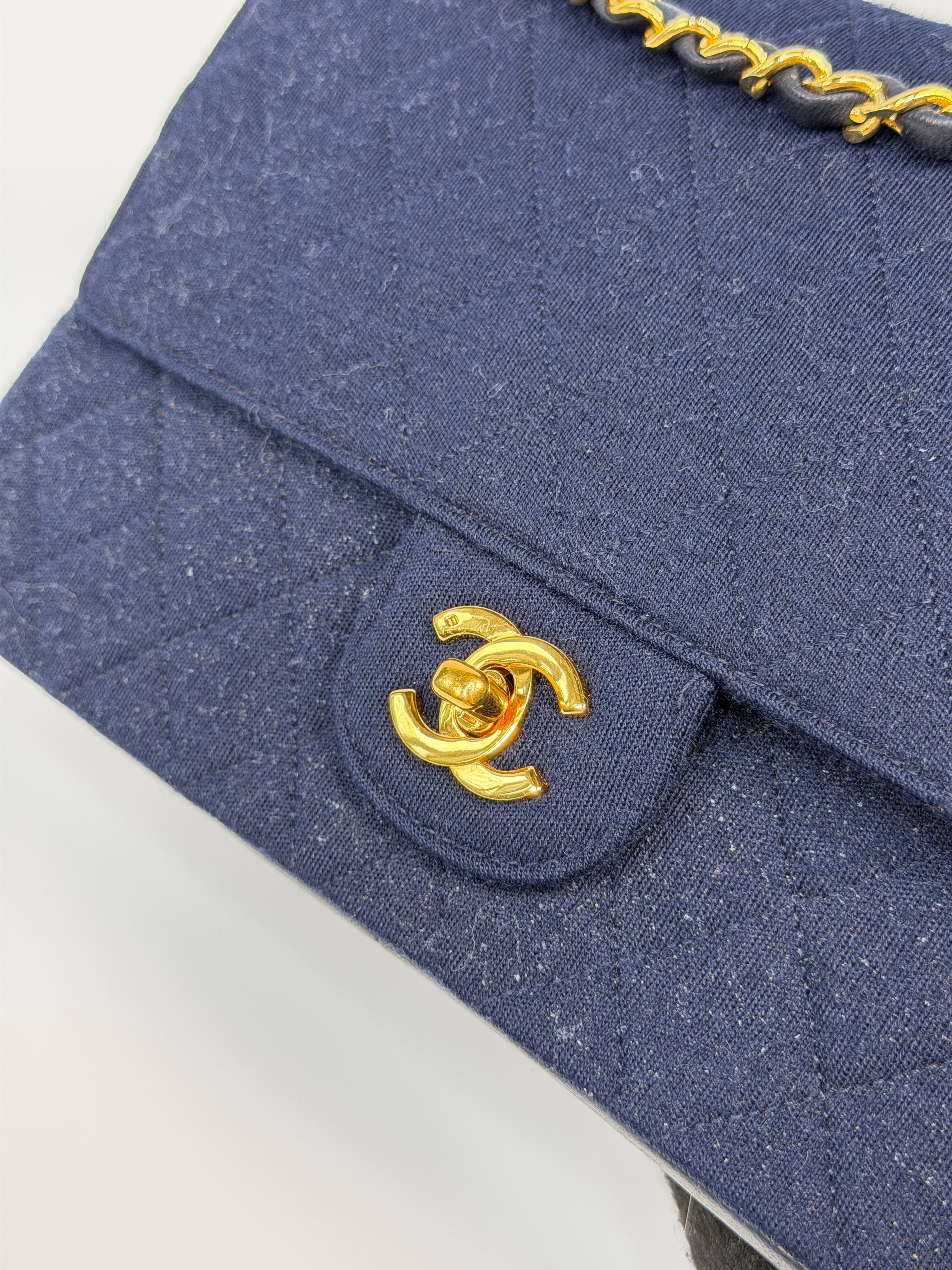 Chanel Vintage Medium Double Flap Navy Cotton With 24Kt Gold Hardware. Authentic and preloved in excellent condition.