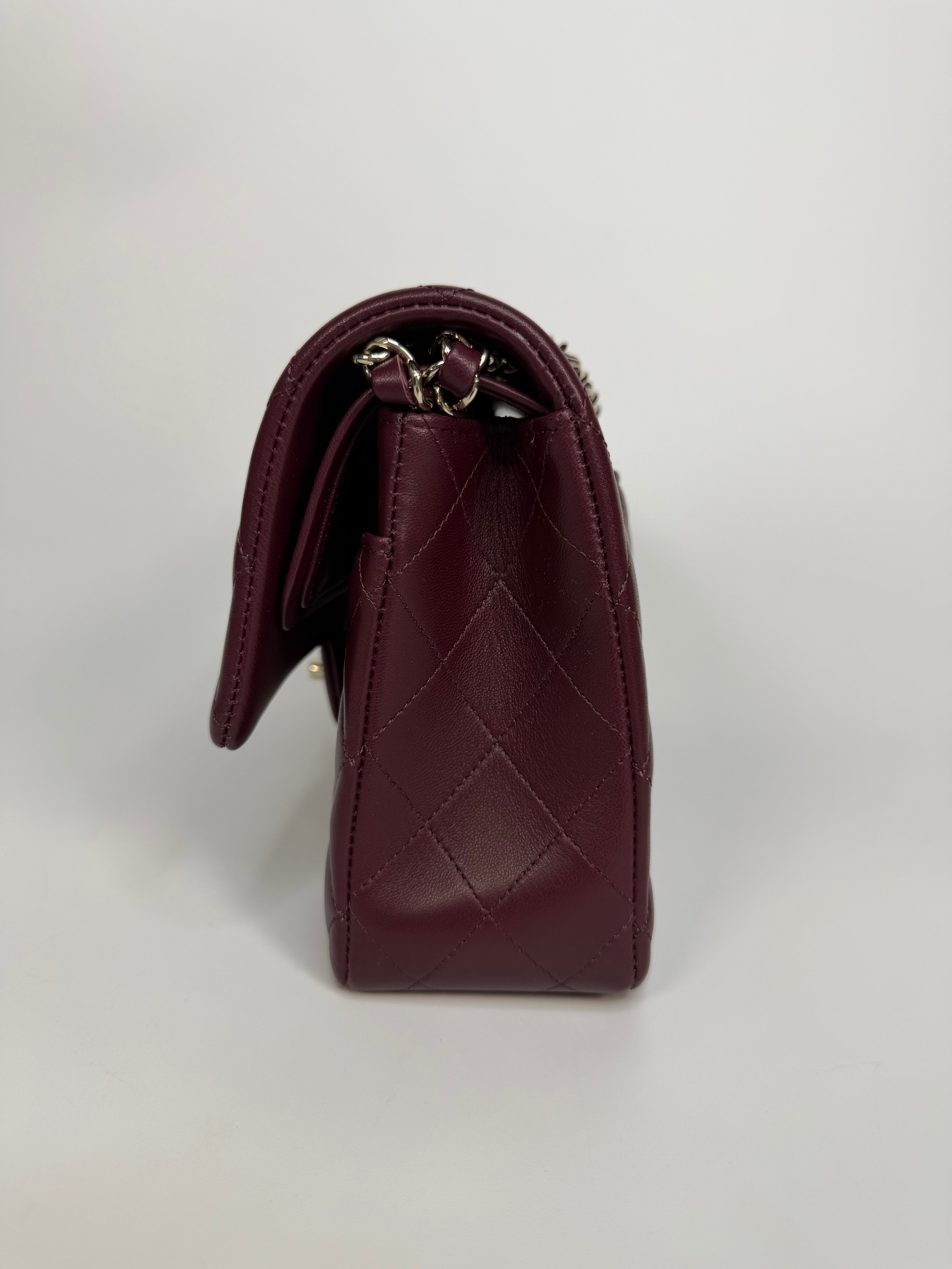 Chanel Medium Classic Double Flap Burgundy Lambskin Leather With Pale Gold Hardware. Authentic and preloved in excellent condition with 100% authenticity guarantee.
