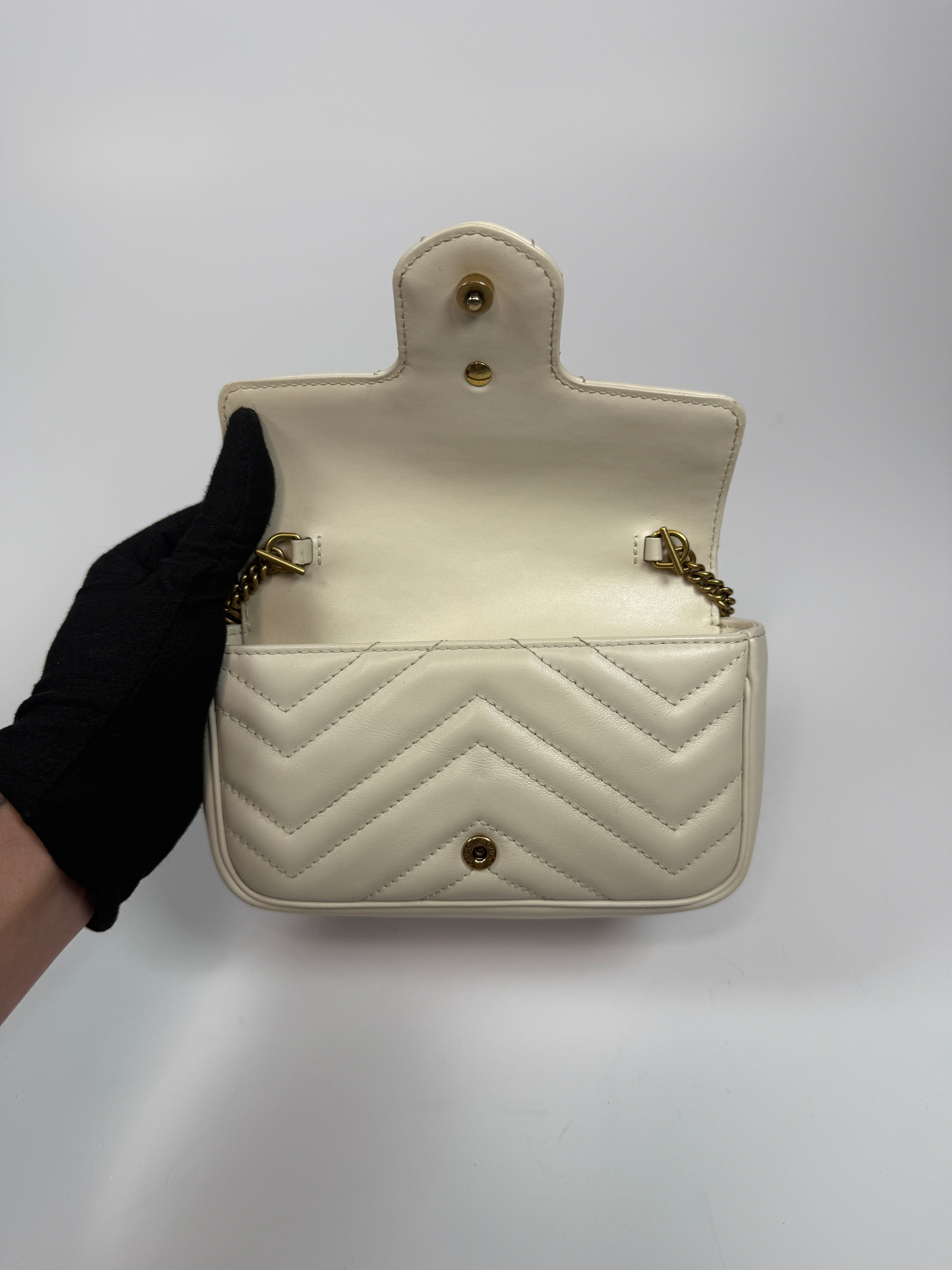 Gucci Marmont White Matelassé Super Mini Bag With Gold Hardware In Excellent pre loved condition. Authentic and preloved