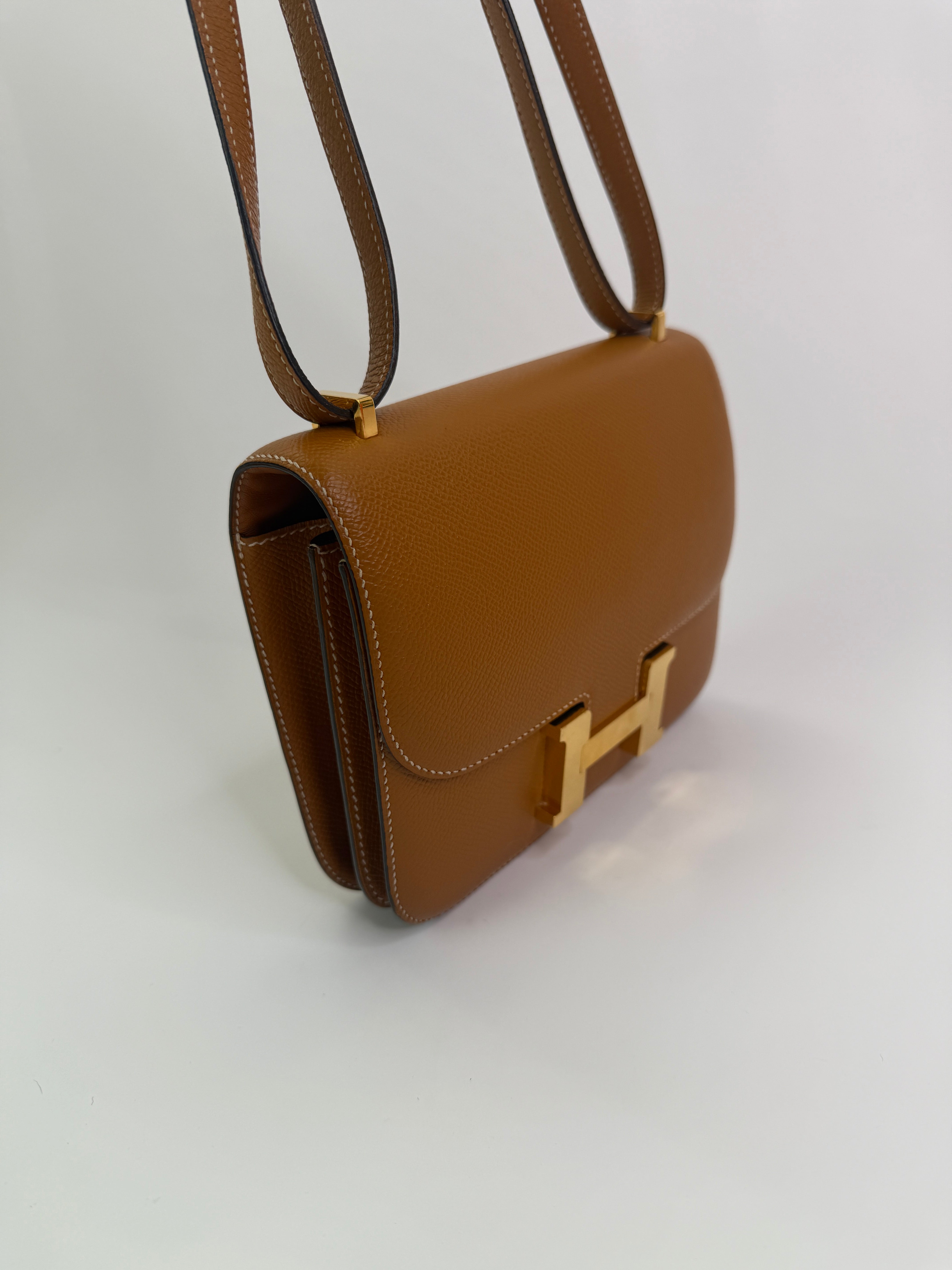 Authentic pre-lovedHermès Constance 18 In Toffee Epsom Leather With Gold Hardware.