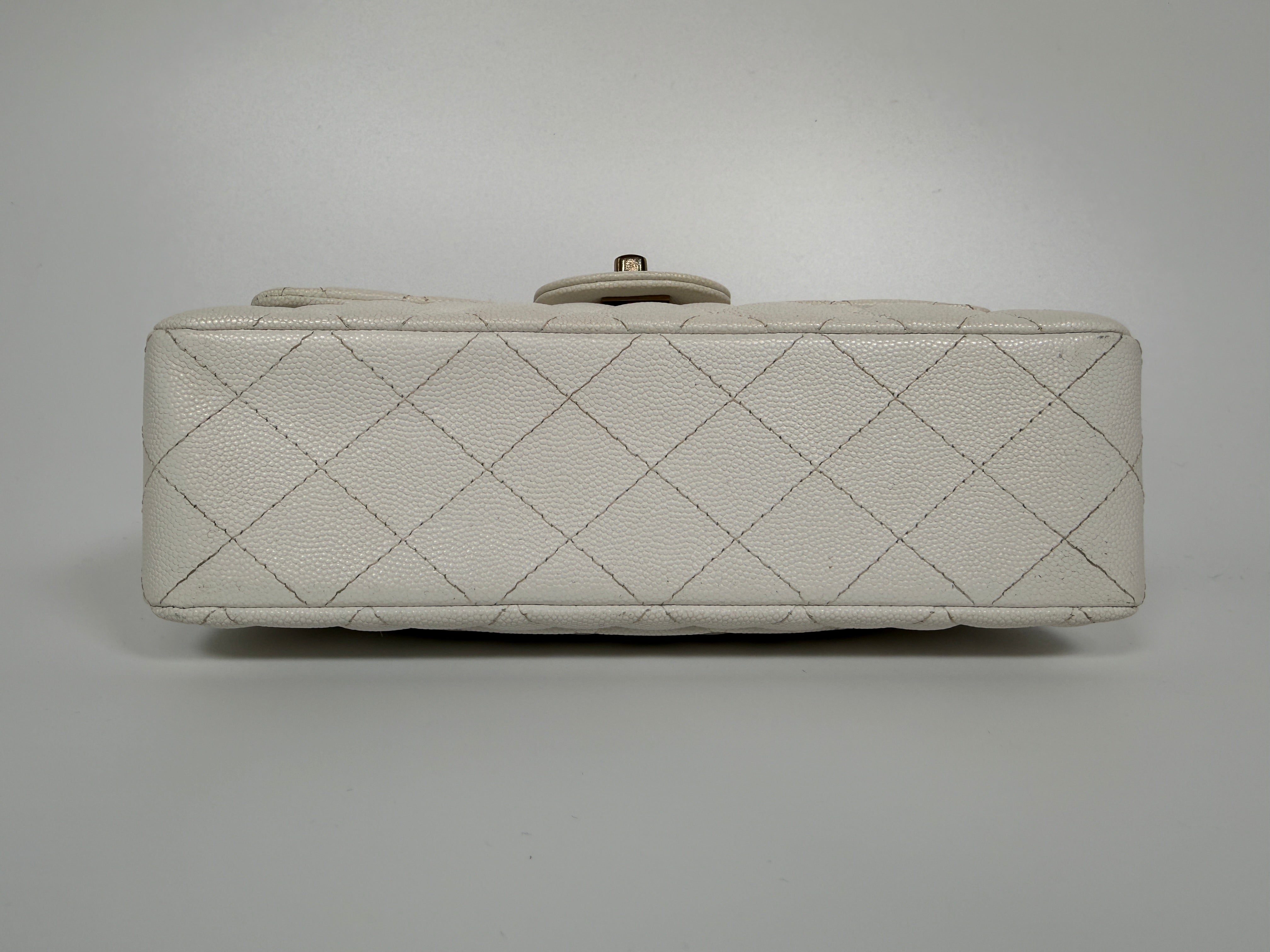 Authentic and preloved Chanel Small Classic Double Flap In White Caviar Leather With pale gold hardware. Very Good Condition. 100% Authenticity guarantee