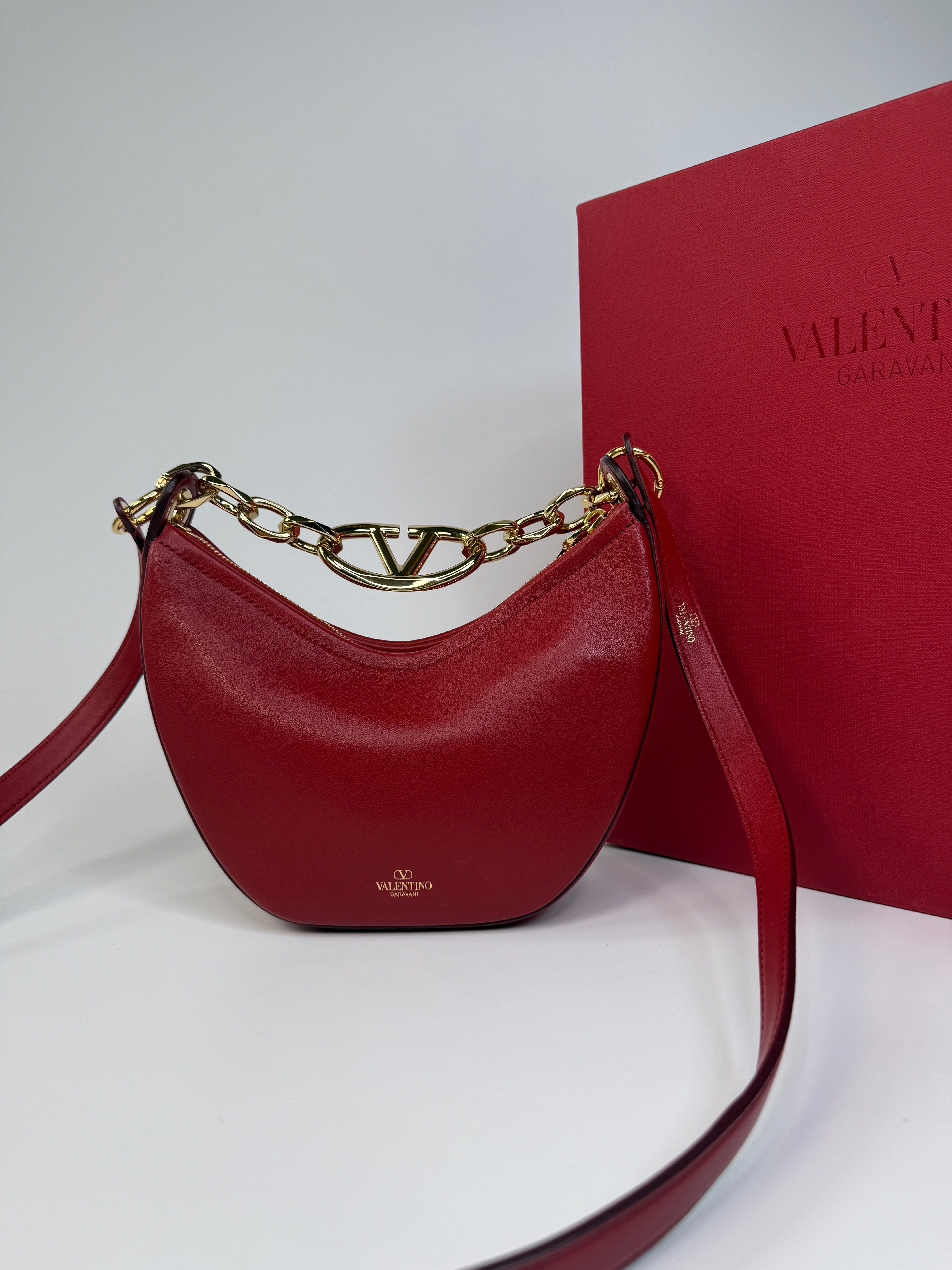 Authentic and preloved Valentino Garavani VLOGO Half Moon Bag In Red Leather With Gold Hardware