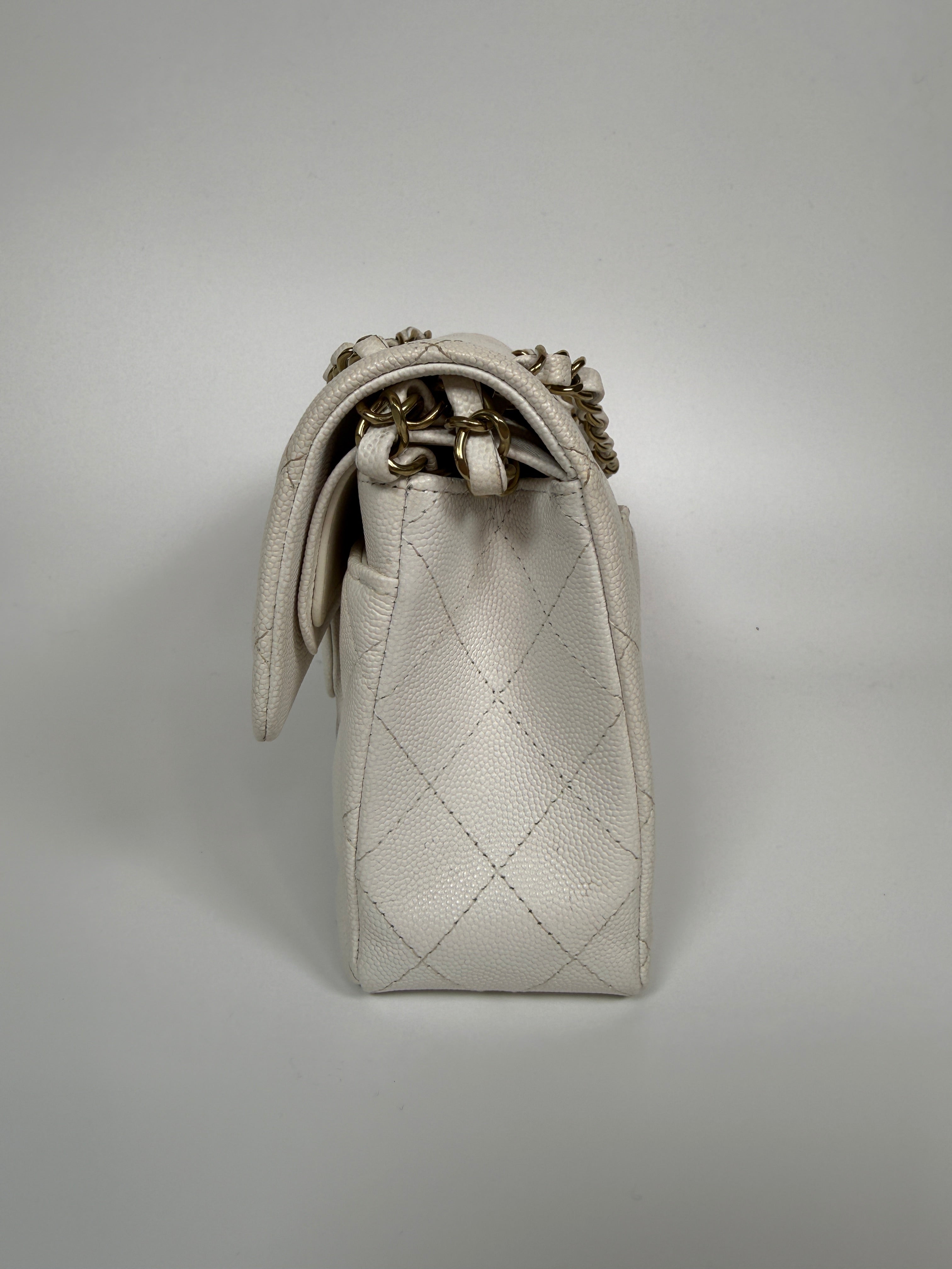 Authentic and preloved Chanel Small Classic Double Flap In White Caviar Leather With pale gold hardware. Very Good Condition. 100% Authenticity guarantee