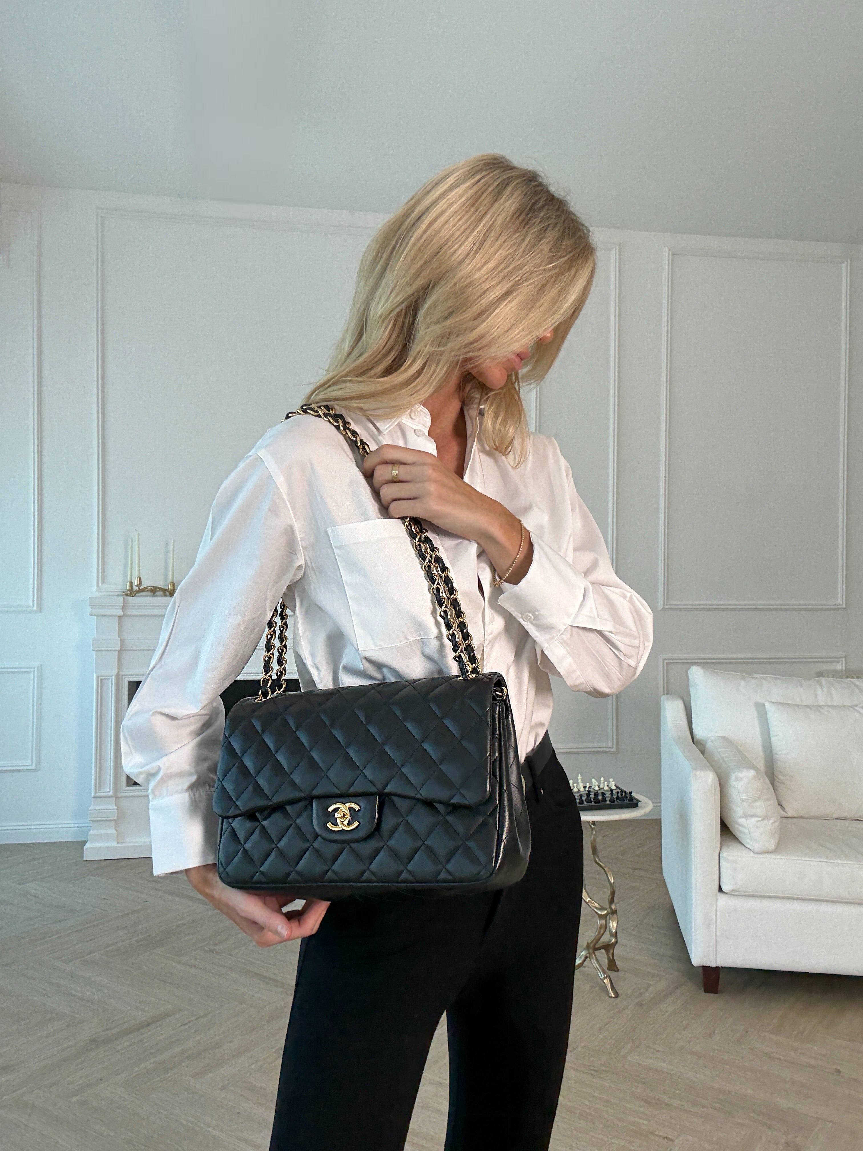 Authentic pre-loved Chanel Black Lambskin Leather Jumbo Classic Double Flap With Gold Hardware.