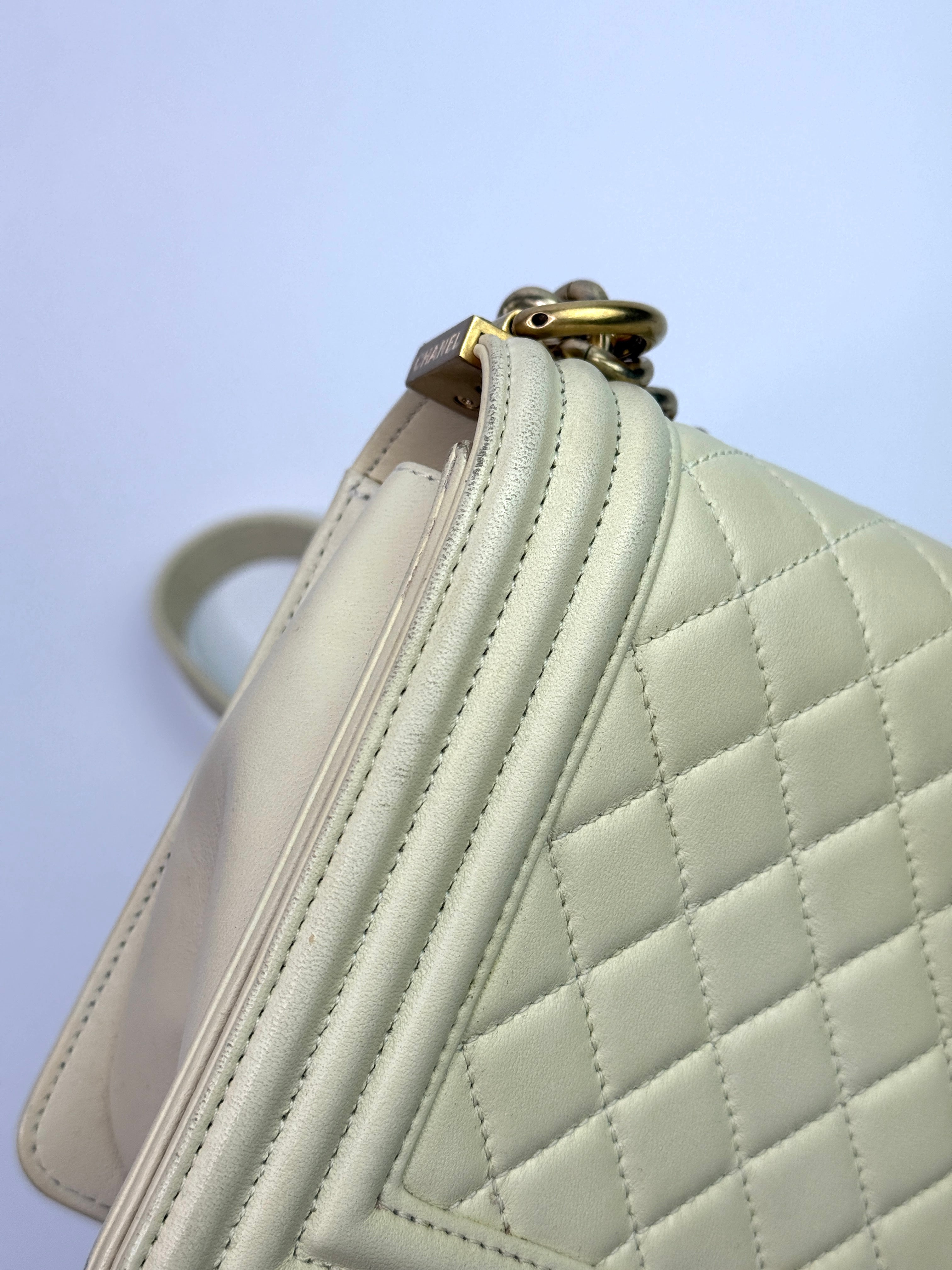 Authentic pre-loved Chanel Boy Bag Medium In Cream Lambskin With Gold Hardware.