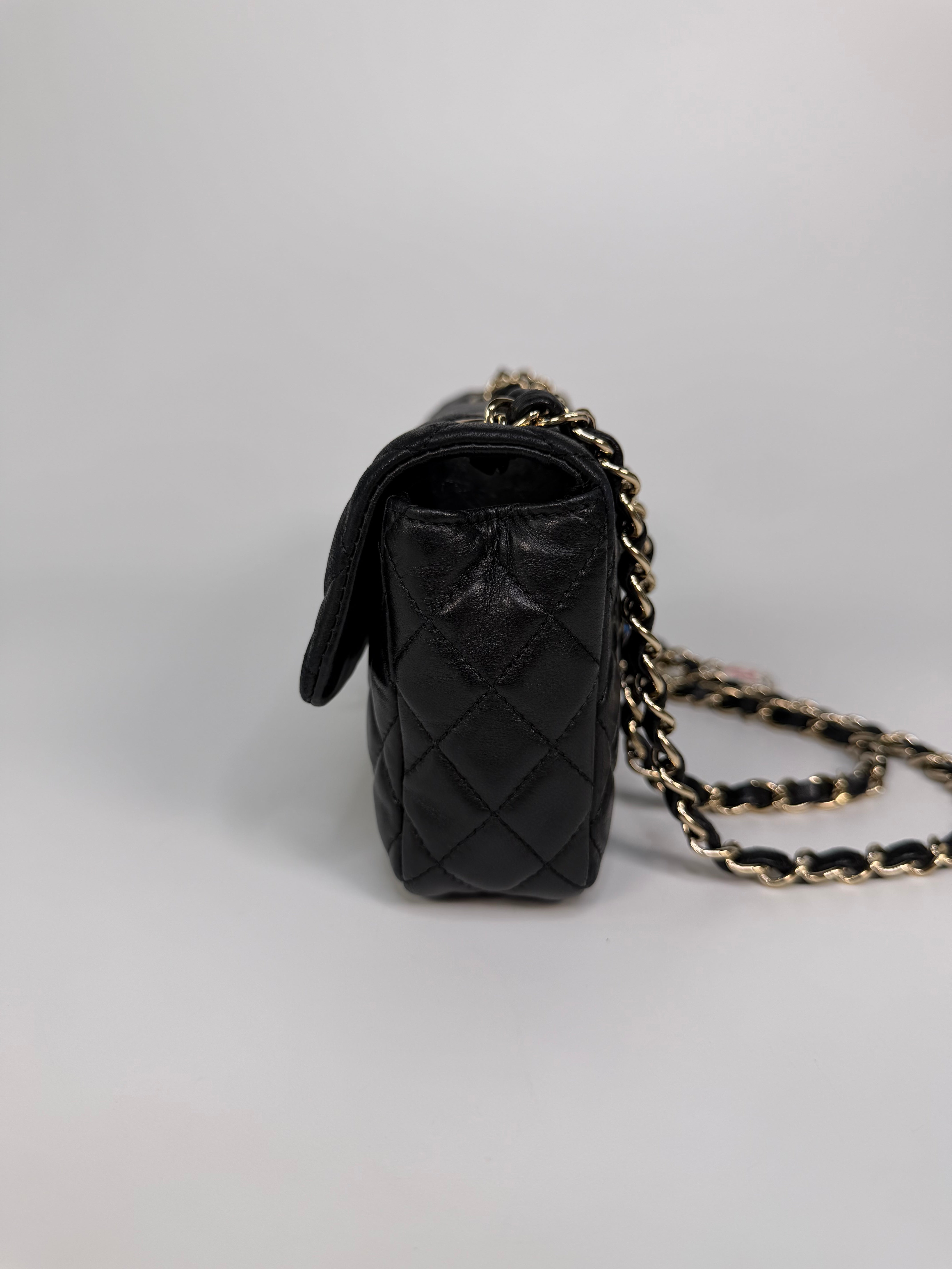 Chanel East West Charms Bag In Black Lambskin Leather With Gold Hardware. Authentic and preloved in excellent condition. 100% guarantee