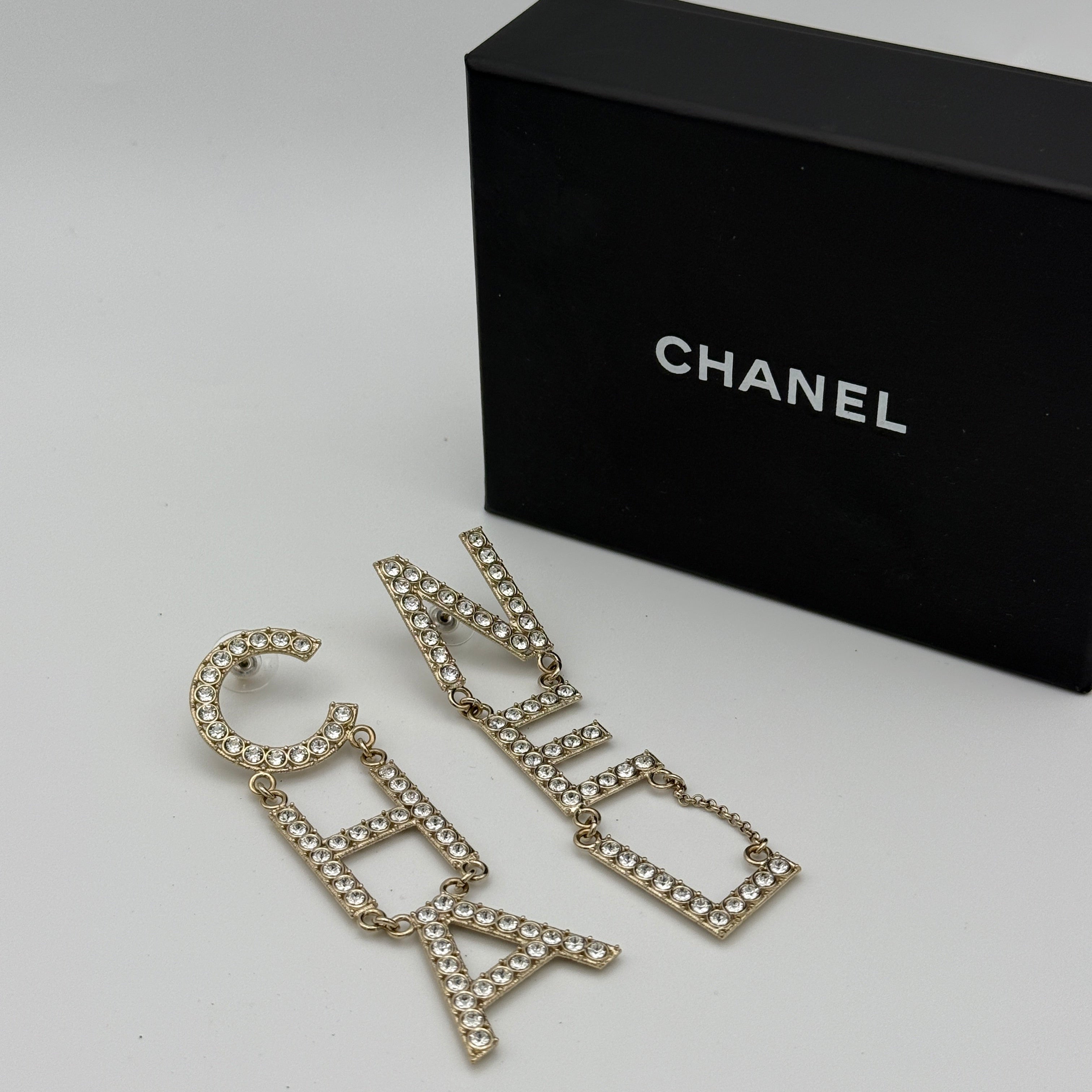 Authentic and preloved Chanel Crystal-Embellished Logo Earrings. 100% Authenticity Guarantee. Verified by Luxe Cheshire