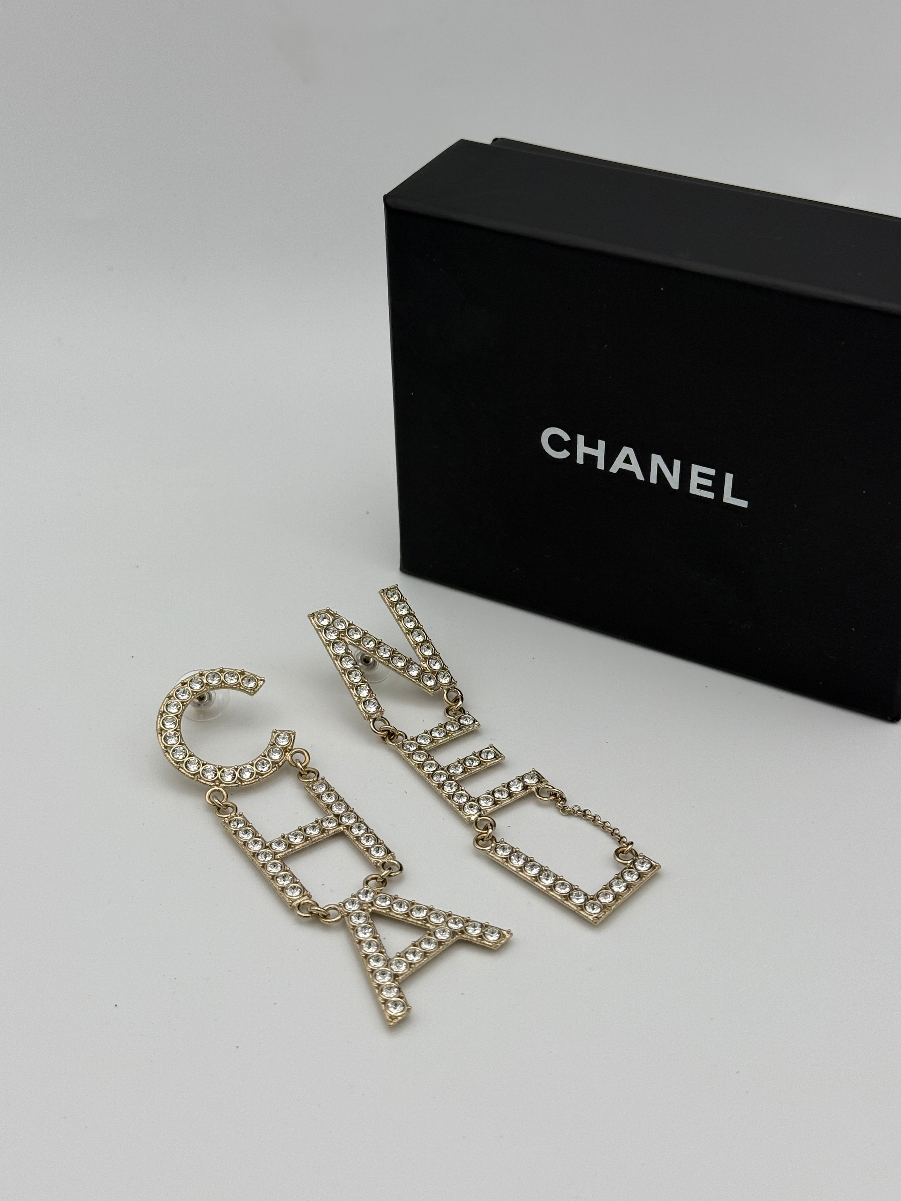 Authentic and preloved Chanel Crystal-Embellished Logo Earrings. 100% Authenticity Guarantee. Verified by Luxe Cheshire