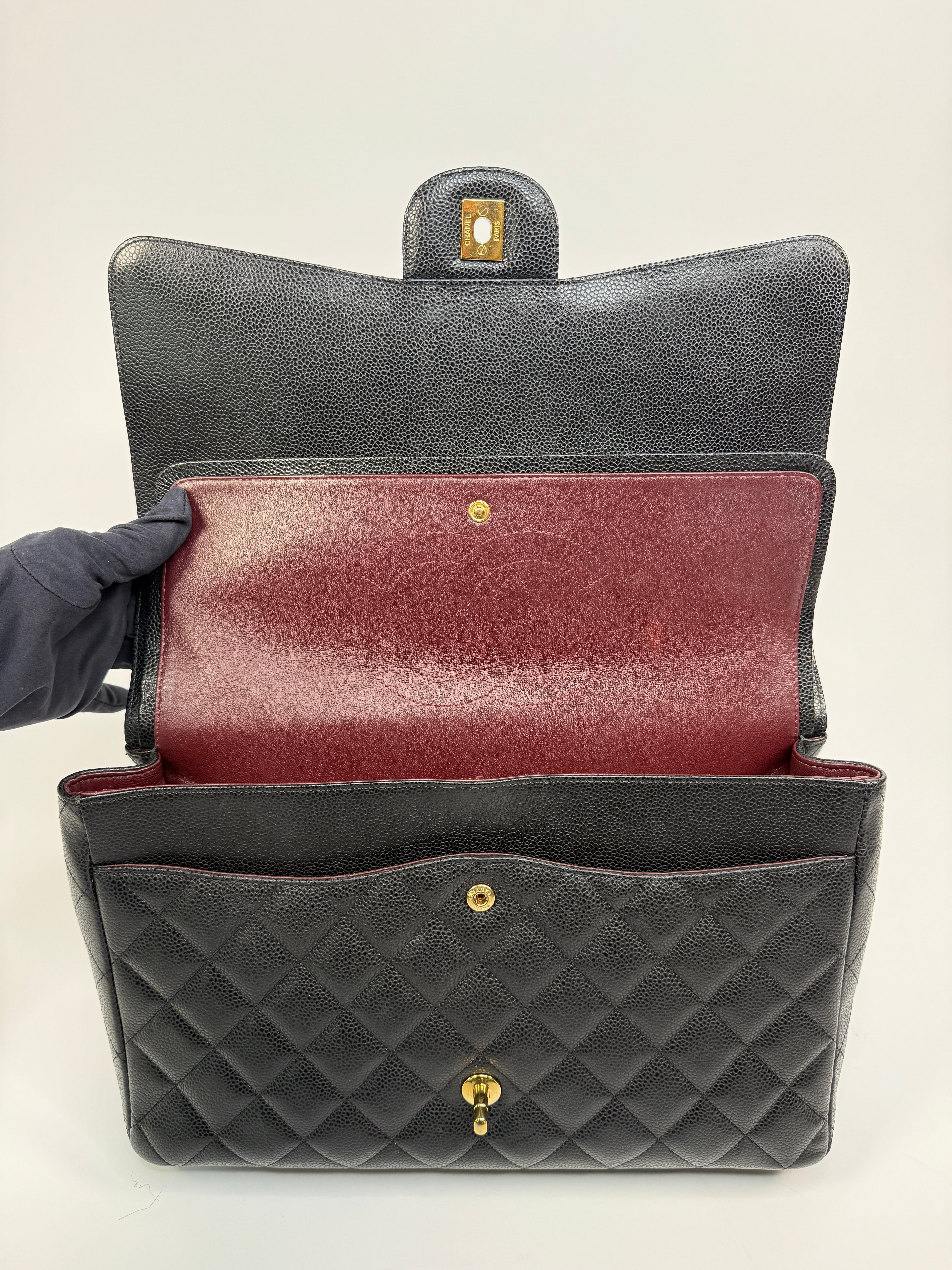 Chanel Maxi Classic Double Flap In Black Caviar Leather With Gold Hardware
Pre Loved & Authentic