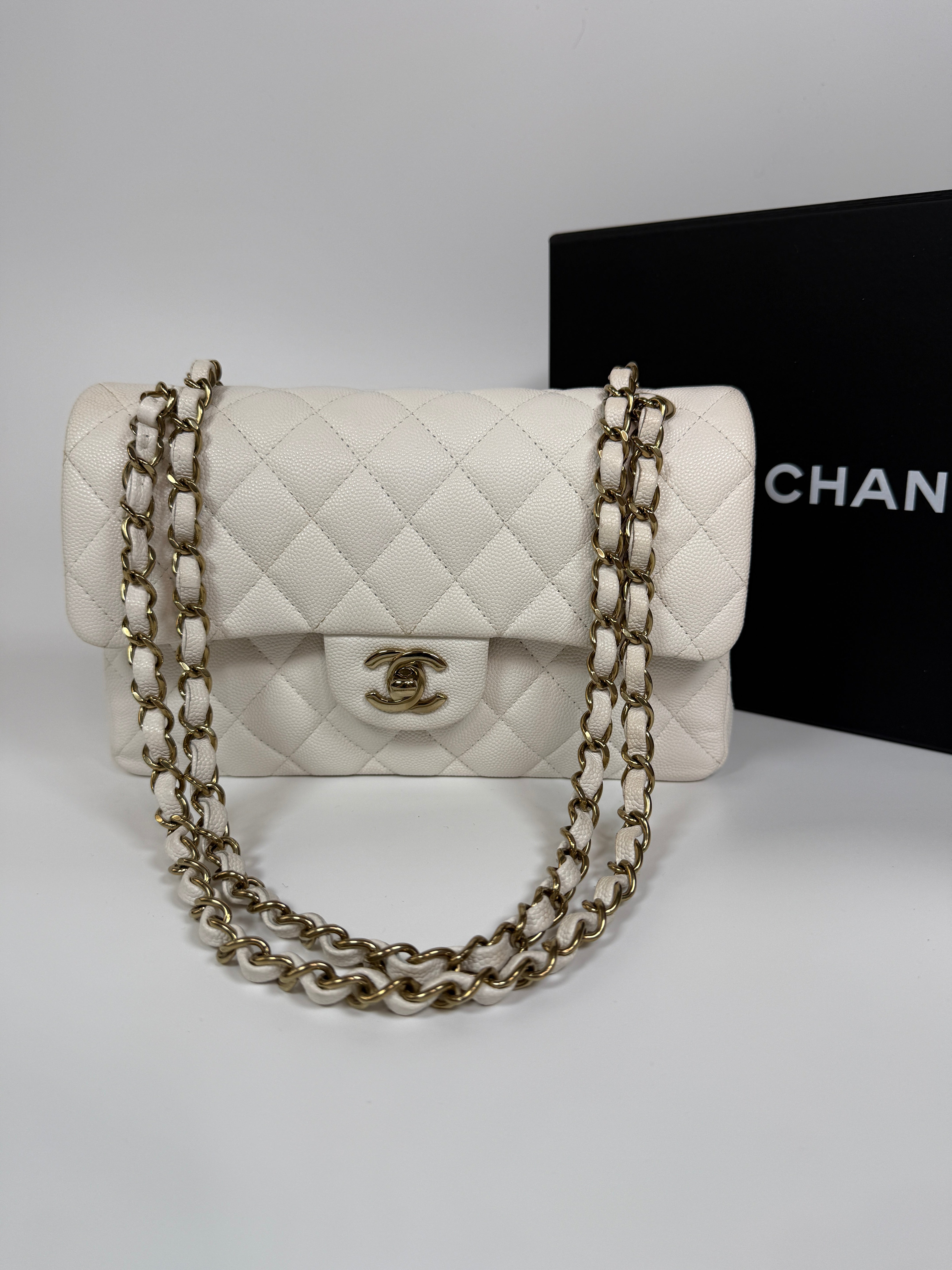 Authentic and preloved Chanel Small Classic Double Flap In White Caviar Leather With pale gold hardware. Very Good Condition. 100% Authenticity guarantee