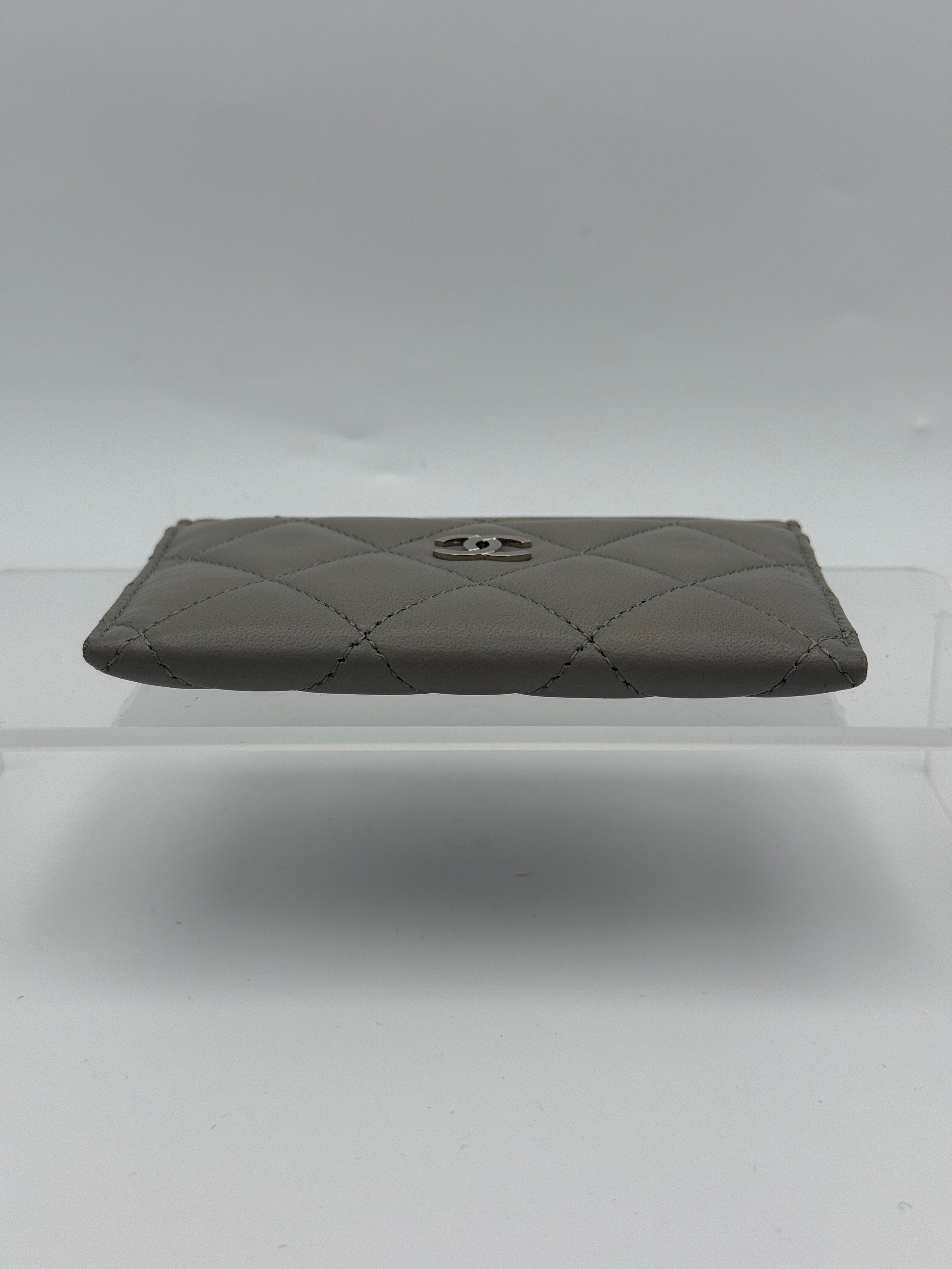 Authentic and pre loved Chanel Classic Card Holder In Grey Lambskin Leather With Silver hardware. Excellent Condition. 100% Authenticity guarantee.