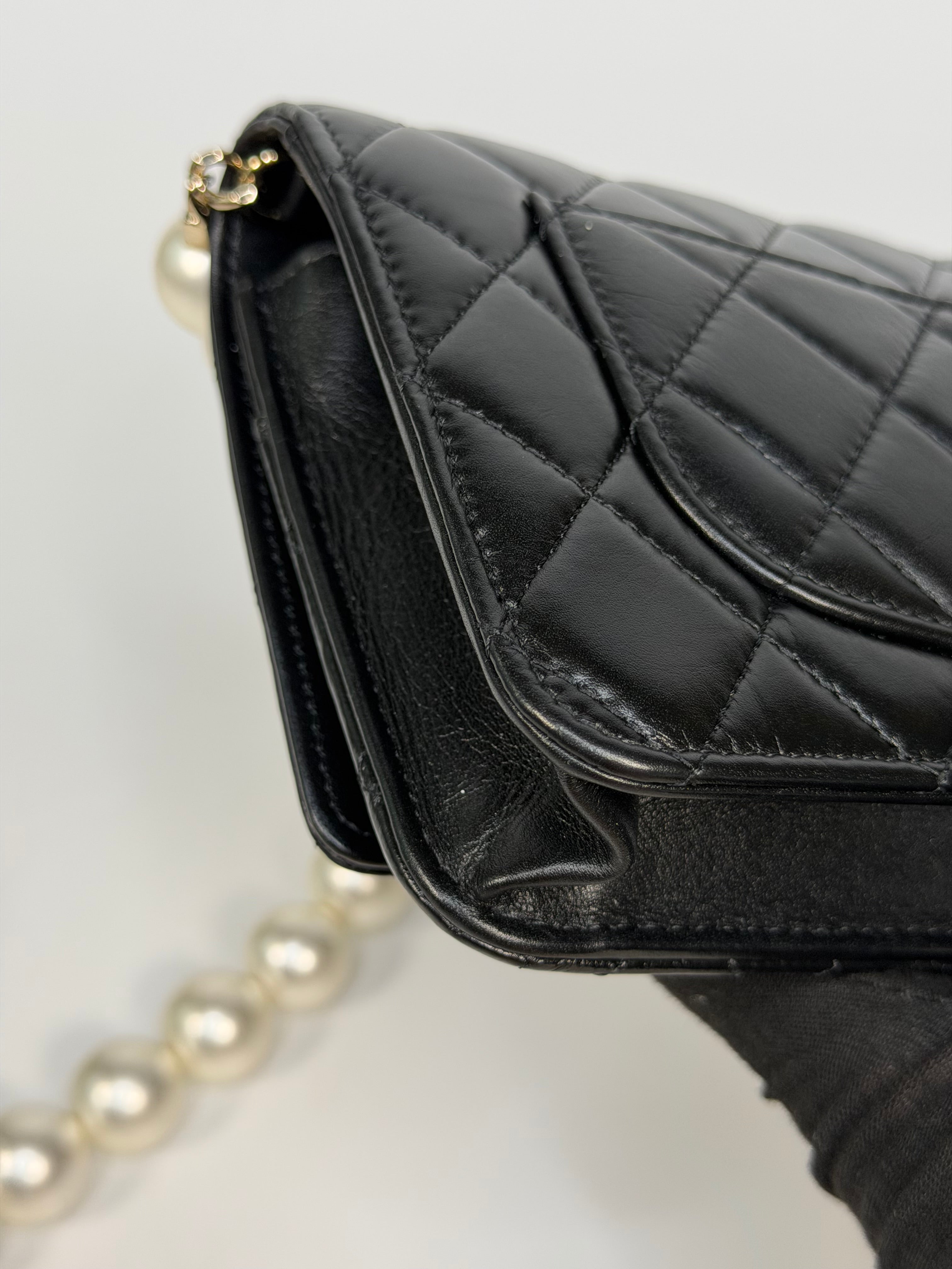 Chanel Pearl Wallet On Chain In Black Lambskin Leather With Gold Hardware. Authentic and preloved in very good condition.