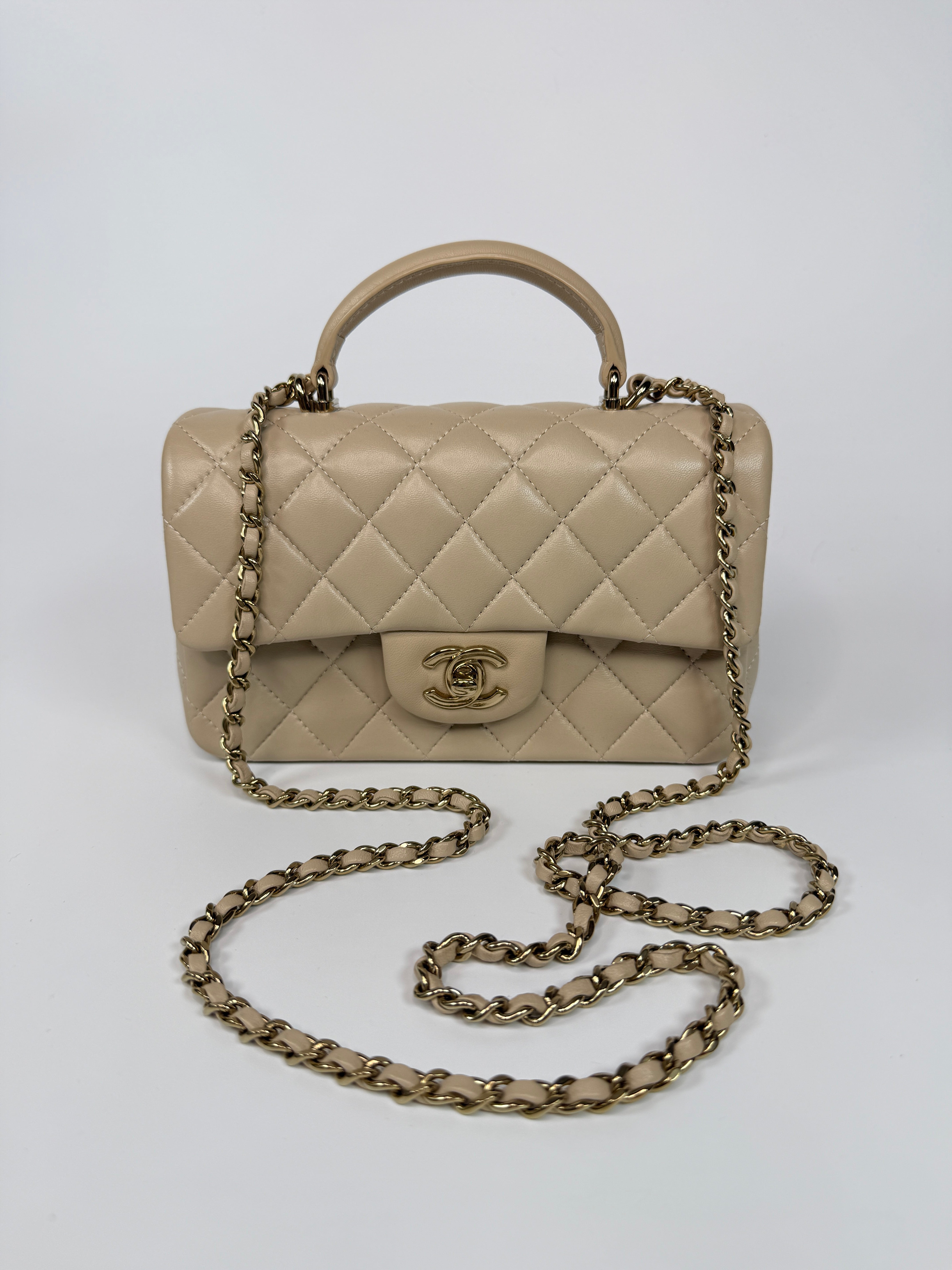 Authentic and preloved Chanel Mini Rectangle Top Handle In Ecru Lambskin With Gold Hardware in excellent condition, Fully insured next day delivery. Verified by Luxe Cheshire. 100% Authenticity guarantee,