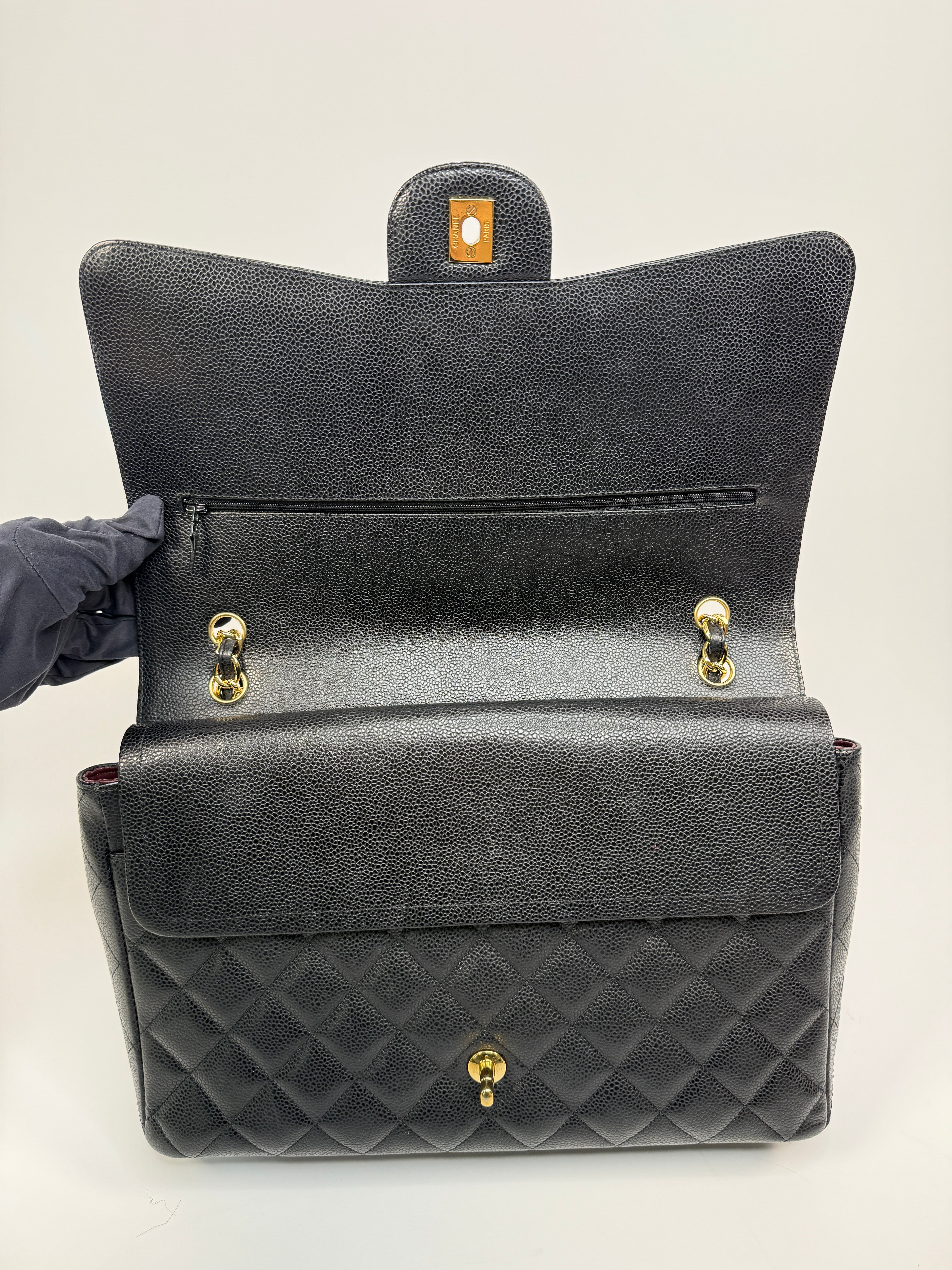 Chanel Maxi Classic Double Flap In Black Caviar Leather With Gold Hardware
Pre Loved & Authentic