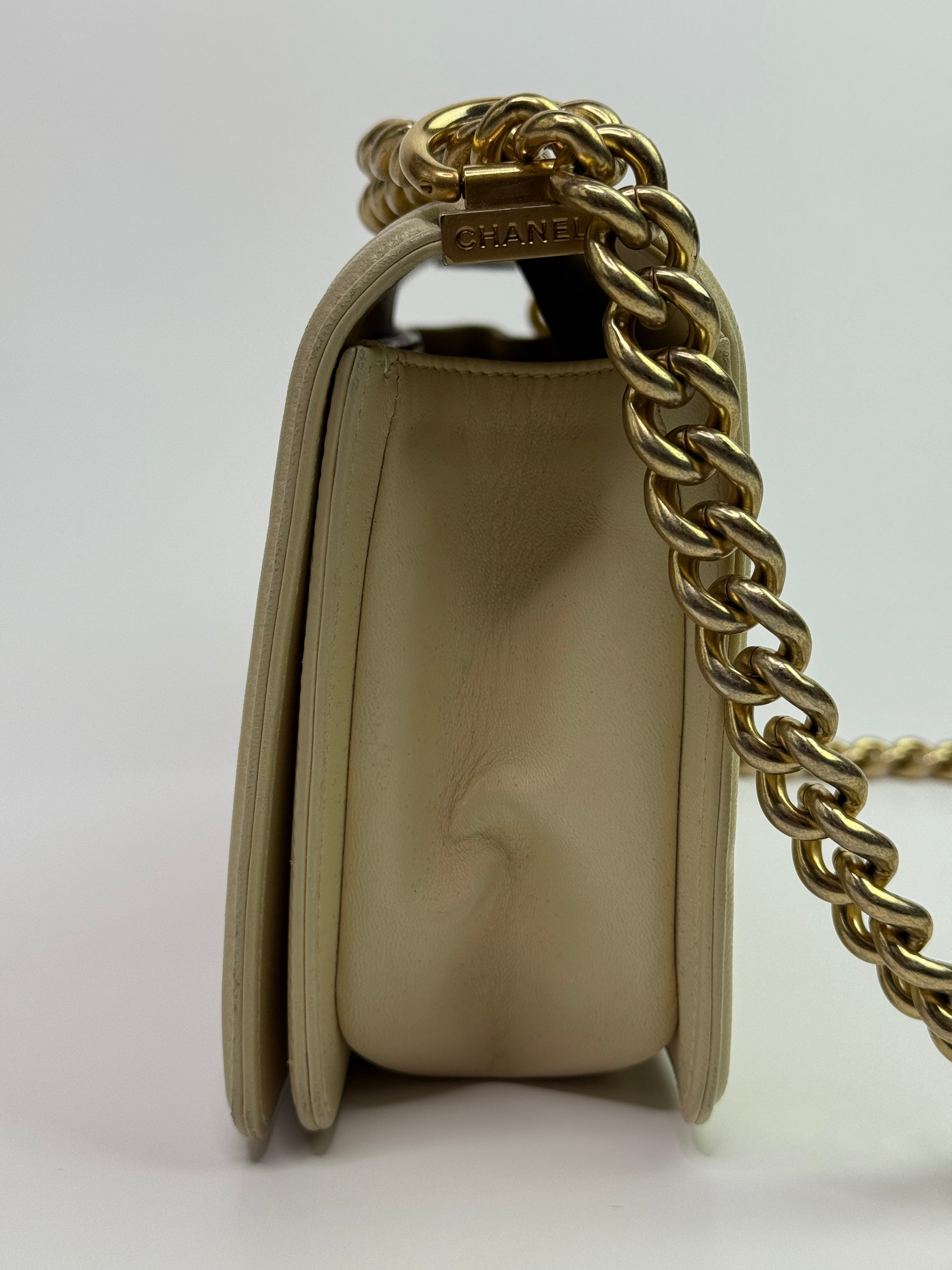 Authentic pre-loved Chanel Boy Bag Medium In Cream Lambskin With Gold Hardware.