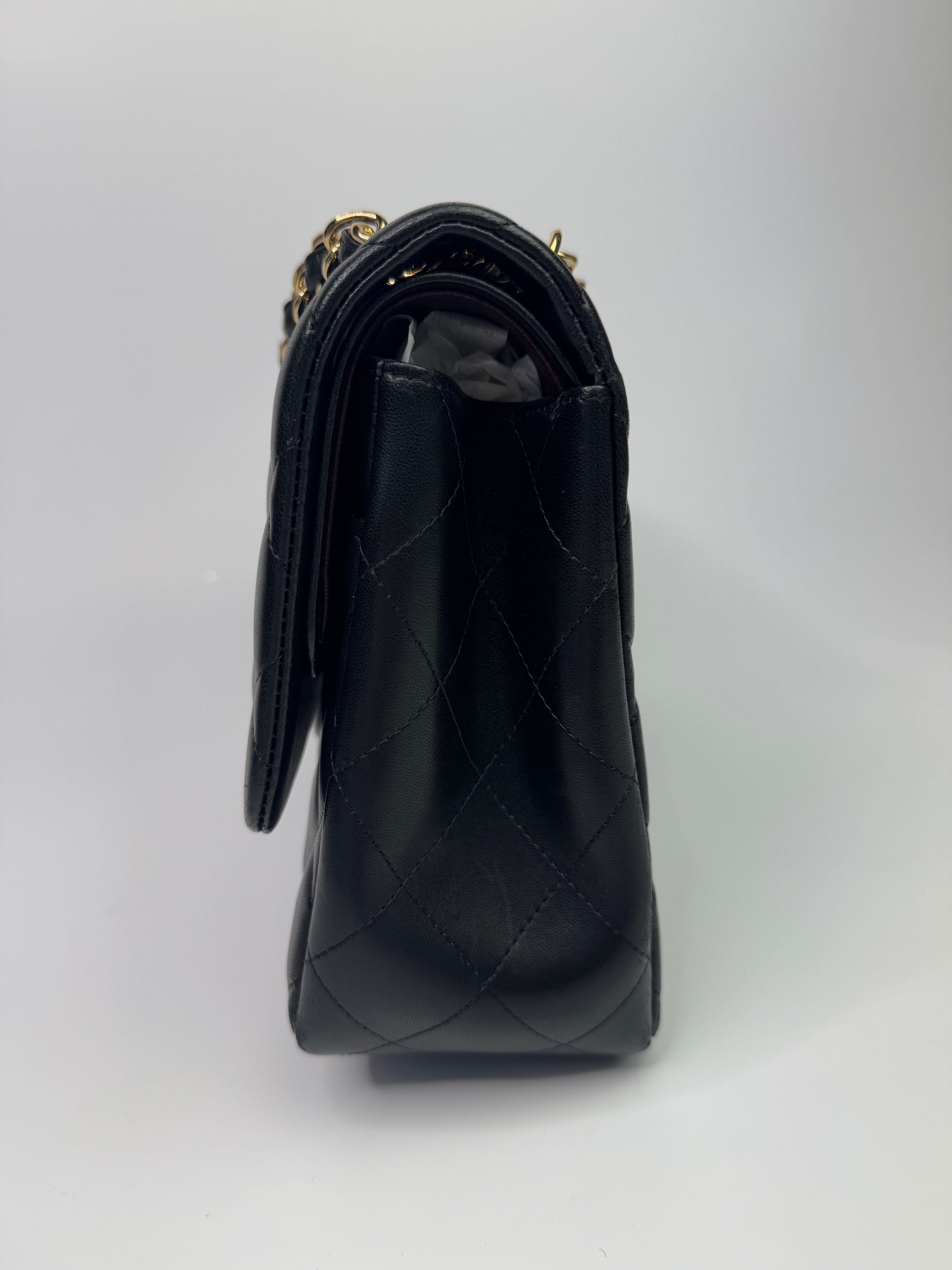 Authentic pre-loved Chanel Black Lambskin Leather Jumbo Classic Double Flap With Gold Hardware.