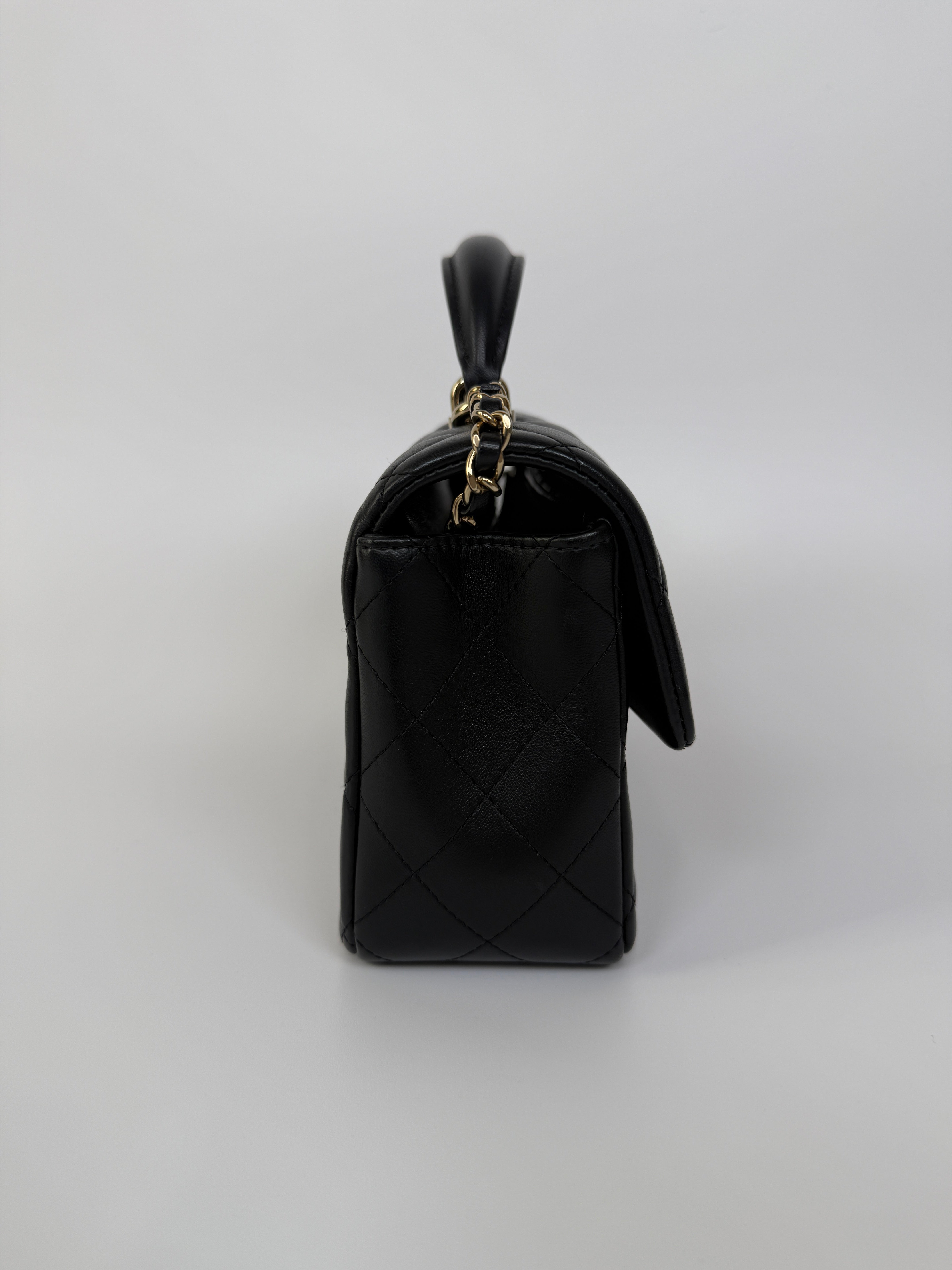 Authentic and preloved Chanel Mini Rectangle Top Handle Flap Bag In Black Lambskin With Gold hardware. Excellent Condition. 100% Authenticity guarantee