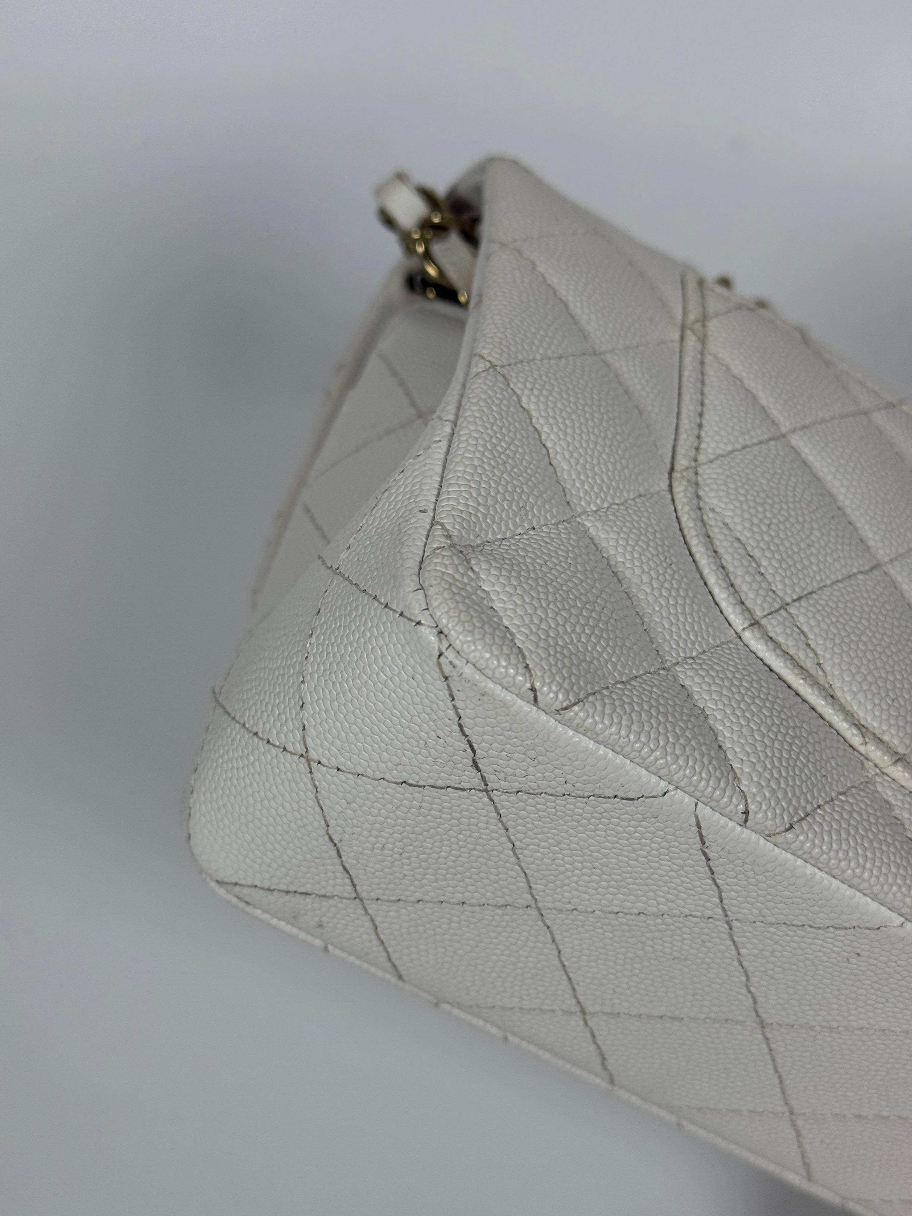 Authentic and preloved Chanel Small Classic Double Flap In White Caviar Leather With pale gold hardware. Very Good Condition. 100% Authenticity guarantee