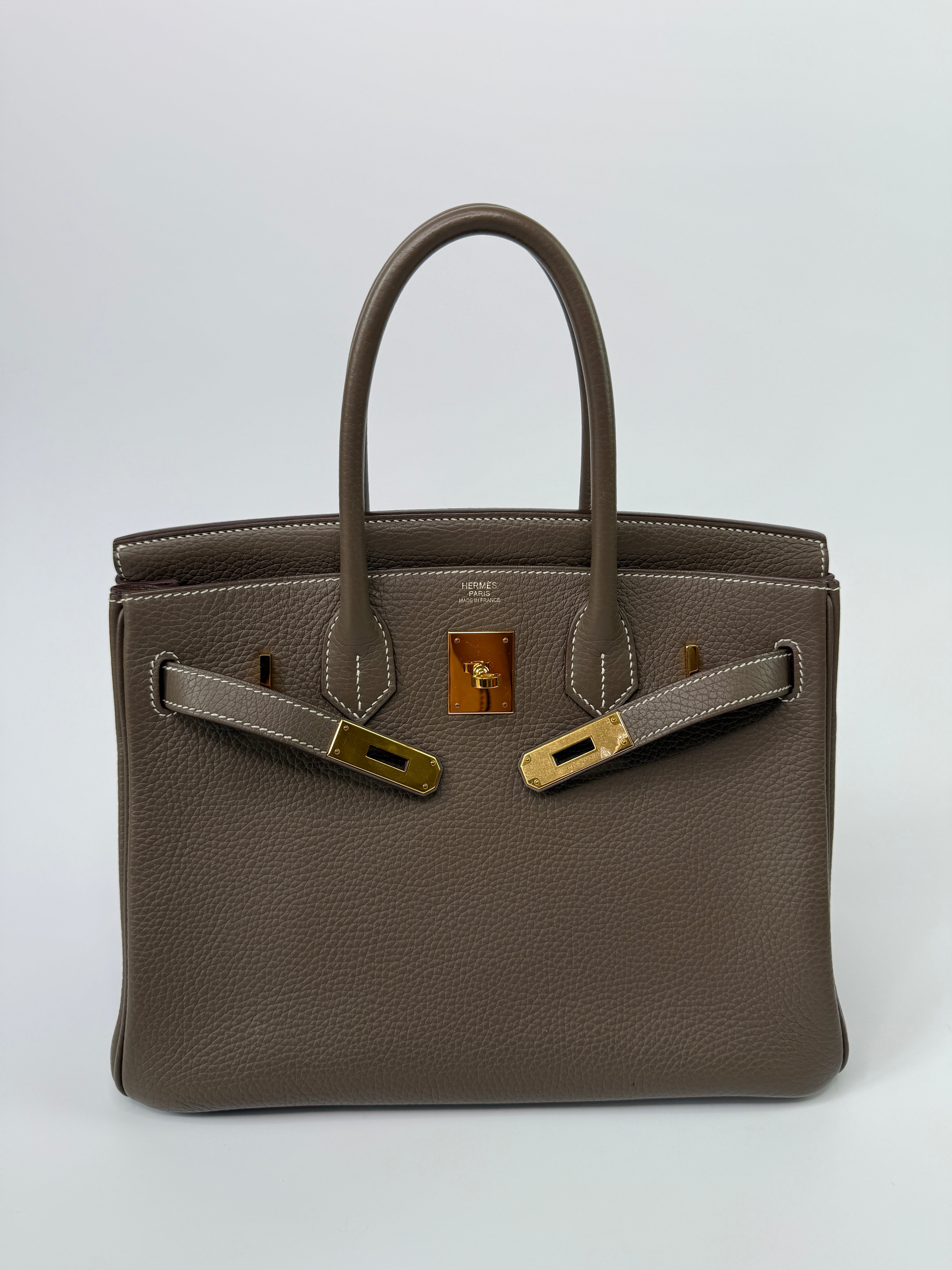 Authentic pre-loved Hermès Birkin 30 In Etoupe Togo Leather With Gold Hardware.