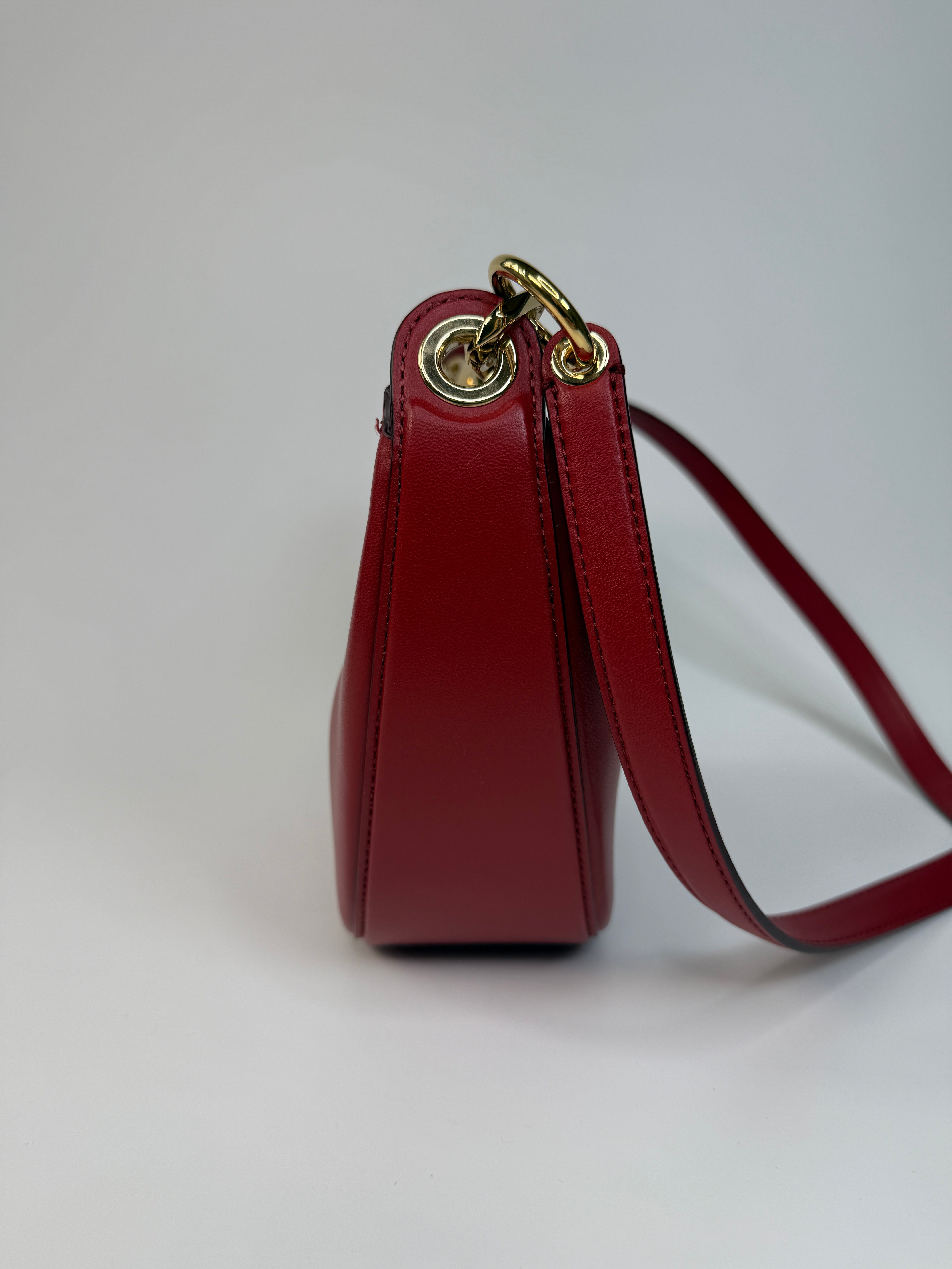 Authentic and preloved Valentino Garavani VLOGO Half Moon Bag In Red Leather With Gold Hardware