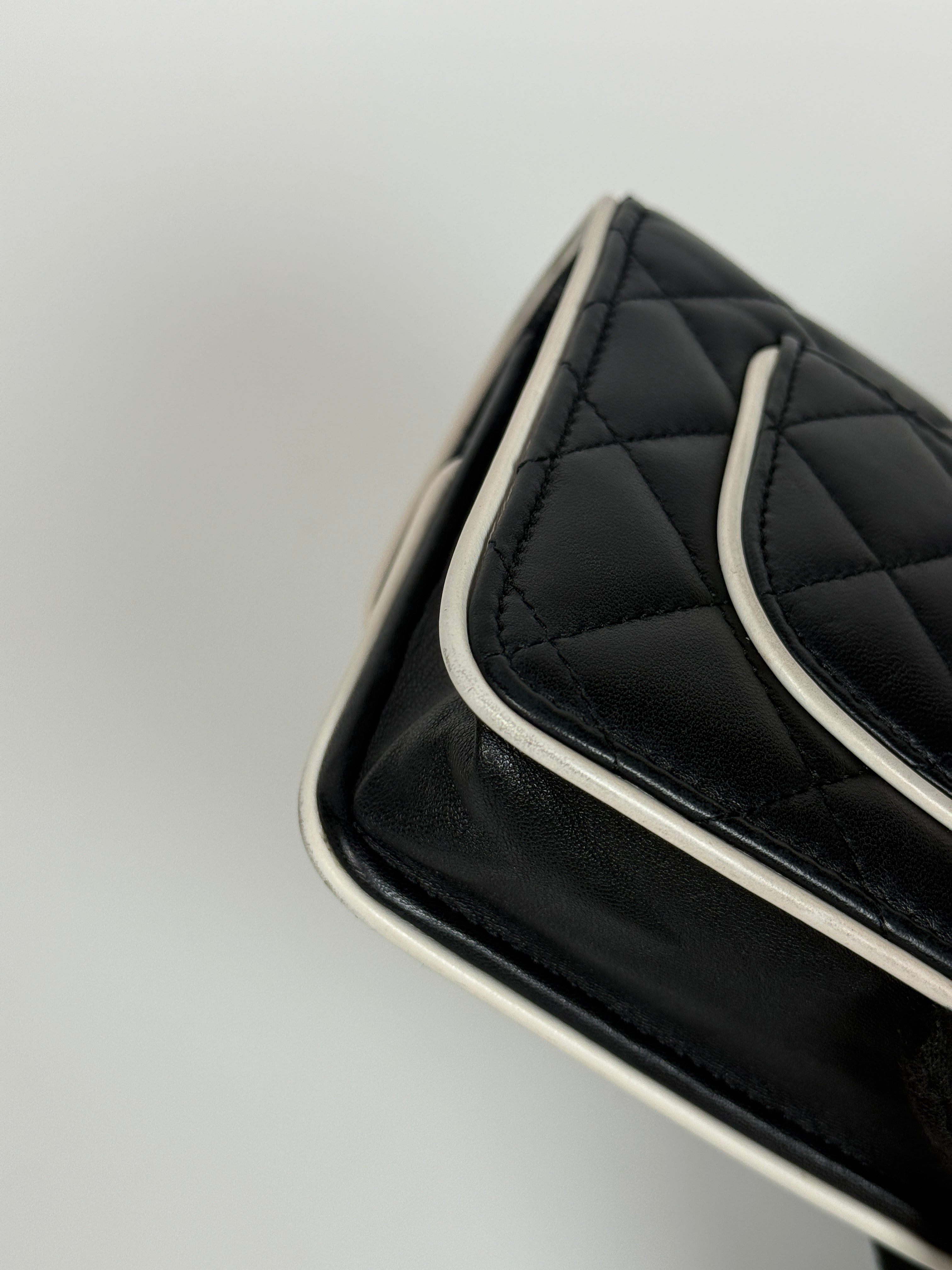 Authentic and preloved Chanel Wallet On Chain In Black & White Lambskin Leather With Pale Gold Hardware. Very Good Condition. 100% Authenticity Guarantee