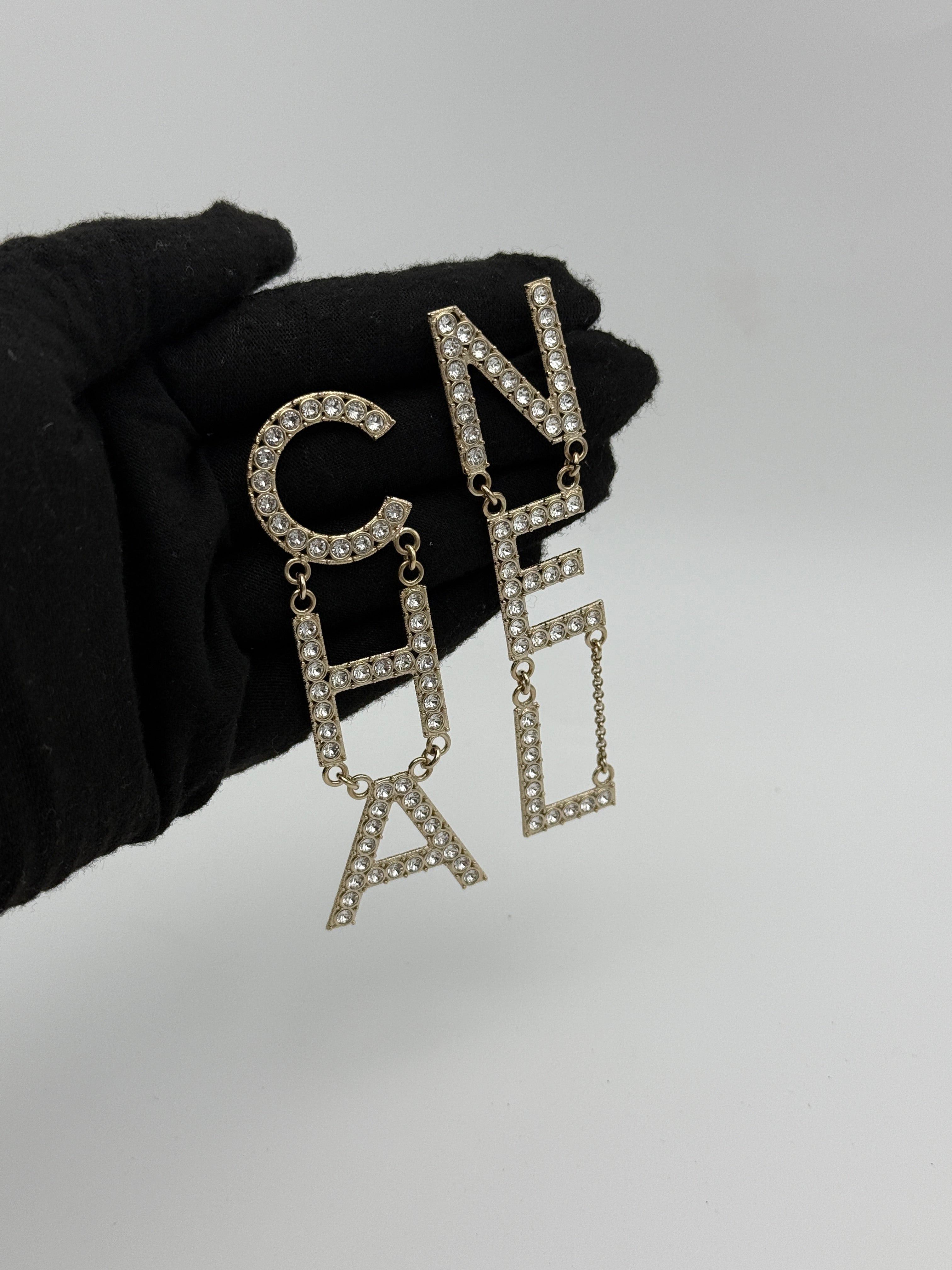 Authentic and preloved Chanel Crystal-Embellished Logo Earrings. 100% Authenticity Guarantee. Verified by Luxe Cheshire
