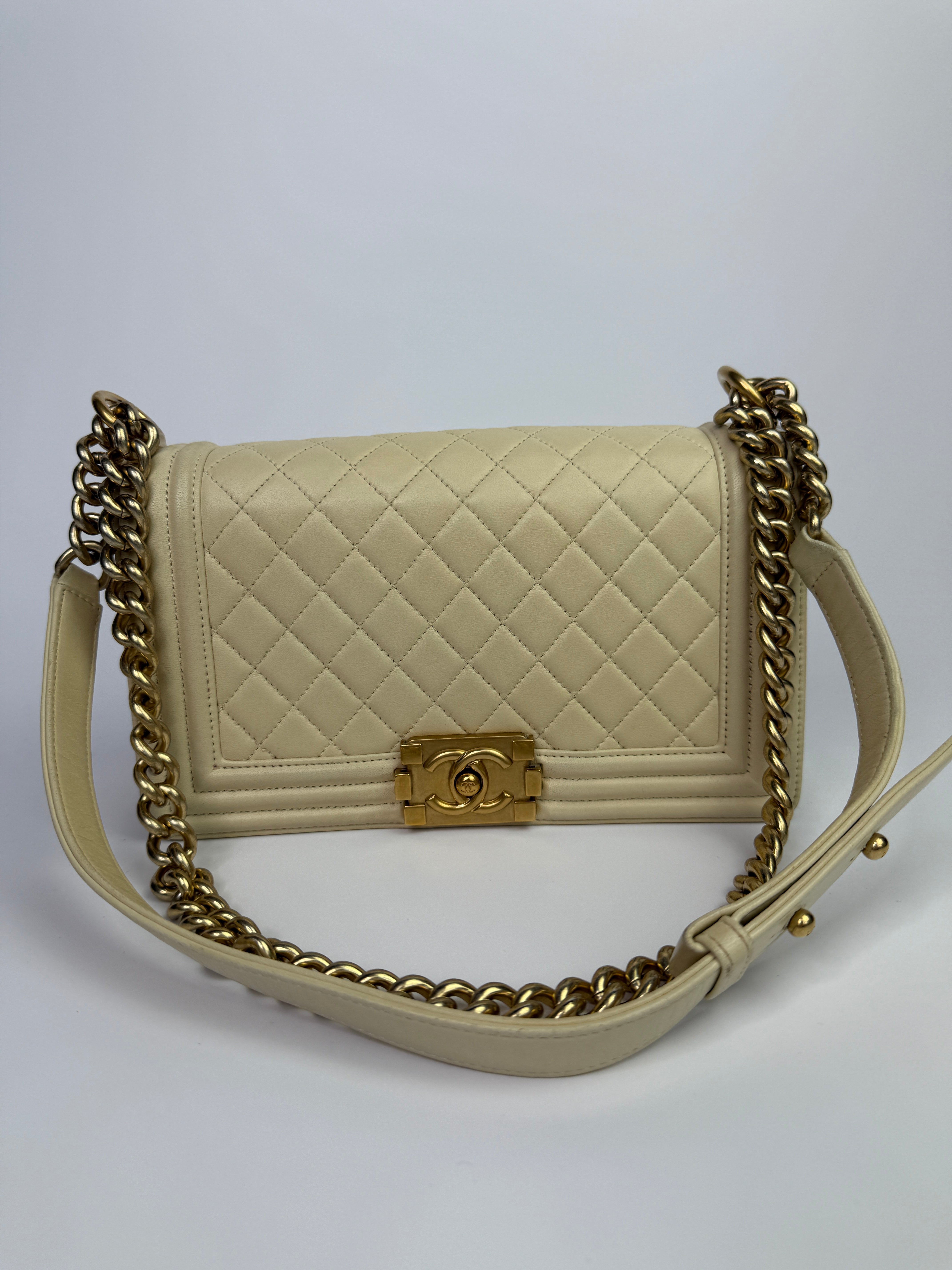 Authentic pre-loved Chanel Boy Bag Medium In Cream Lambskin With Gold Hardware.